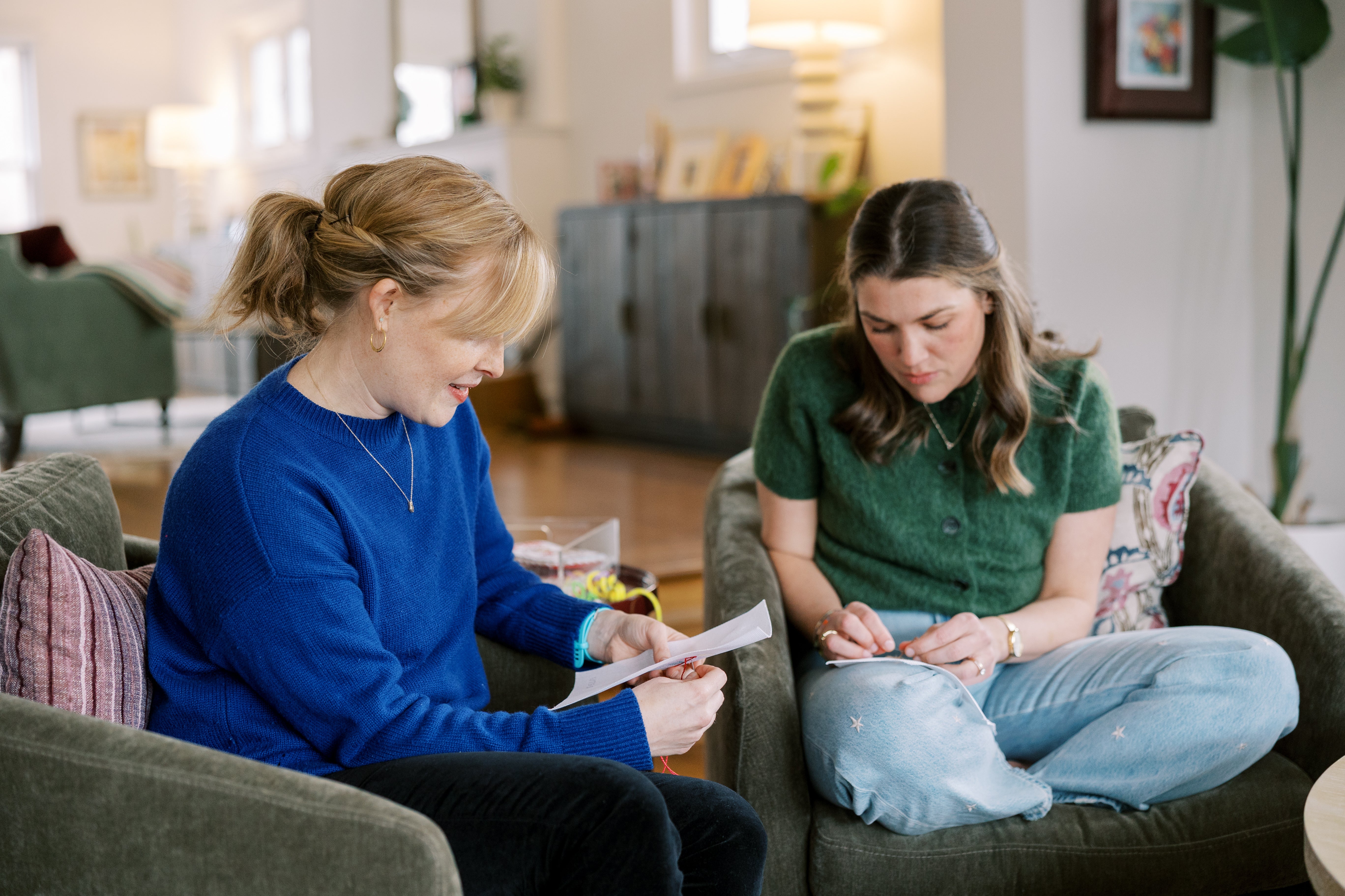 Two women needlepointing together.
