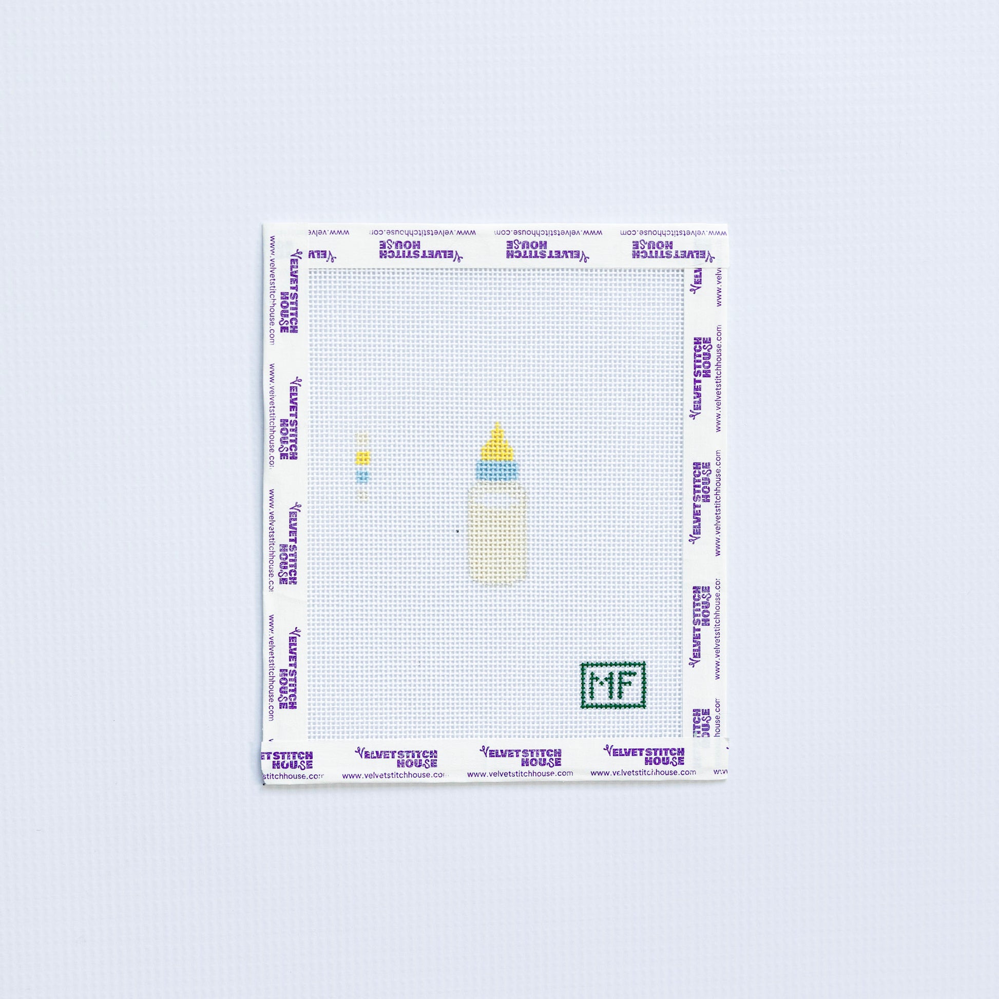 mini needlepoint pattern with cream colored baby bottle 