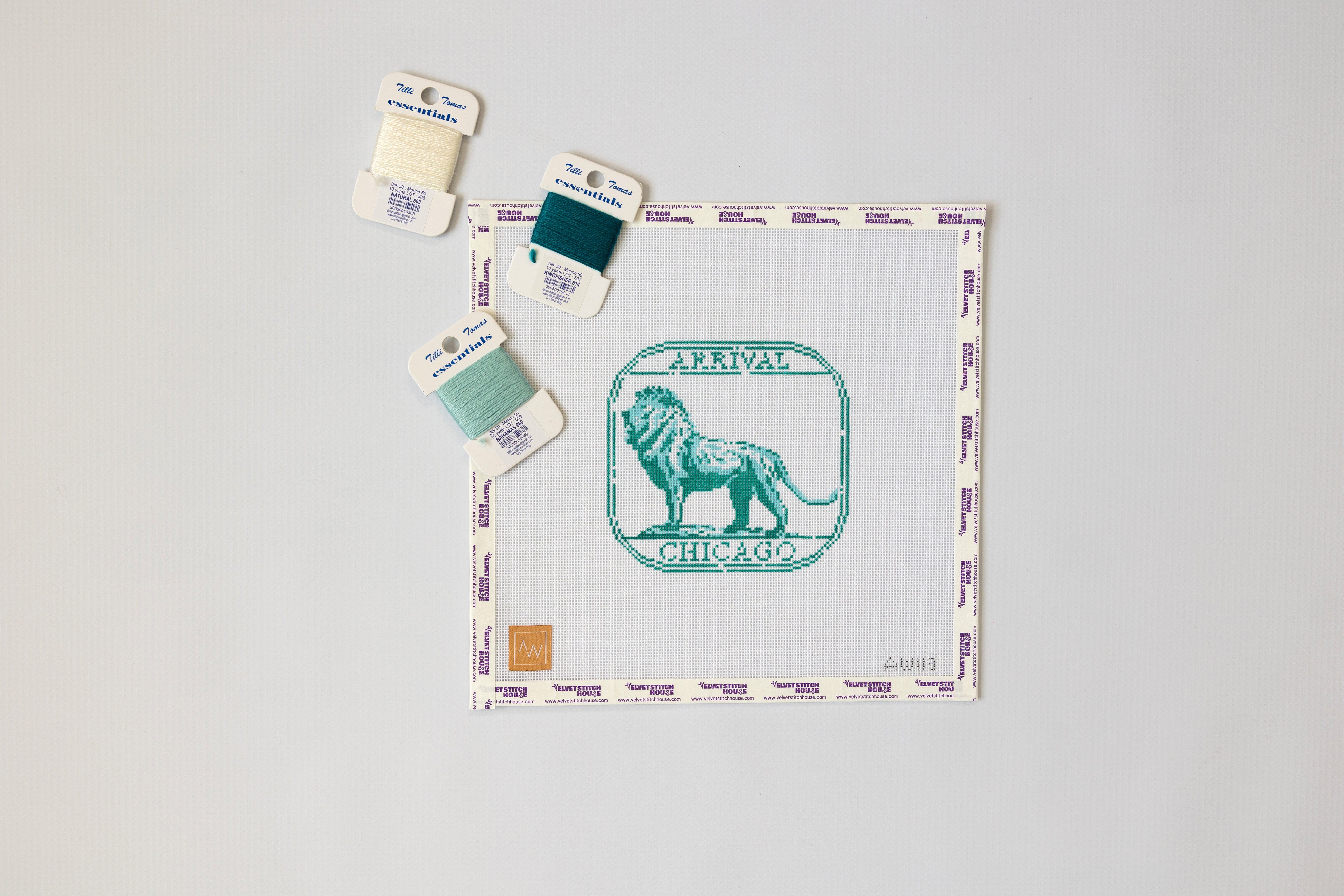 Chicago lion needlepoint canvas passport stamp shown with thread in matching colors. 