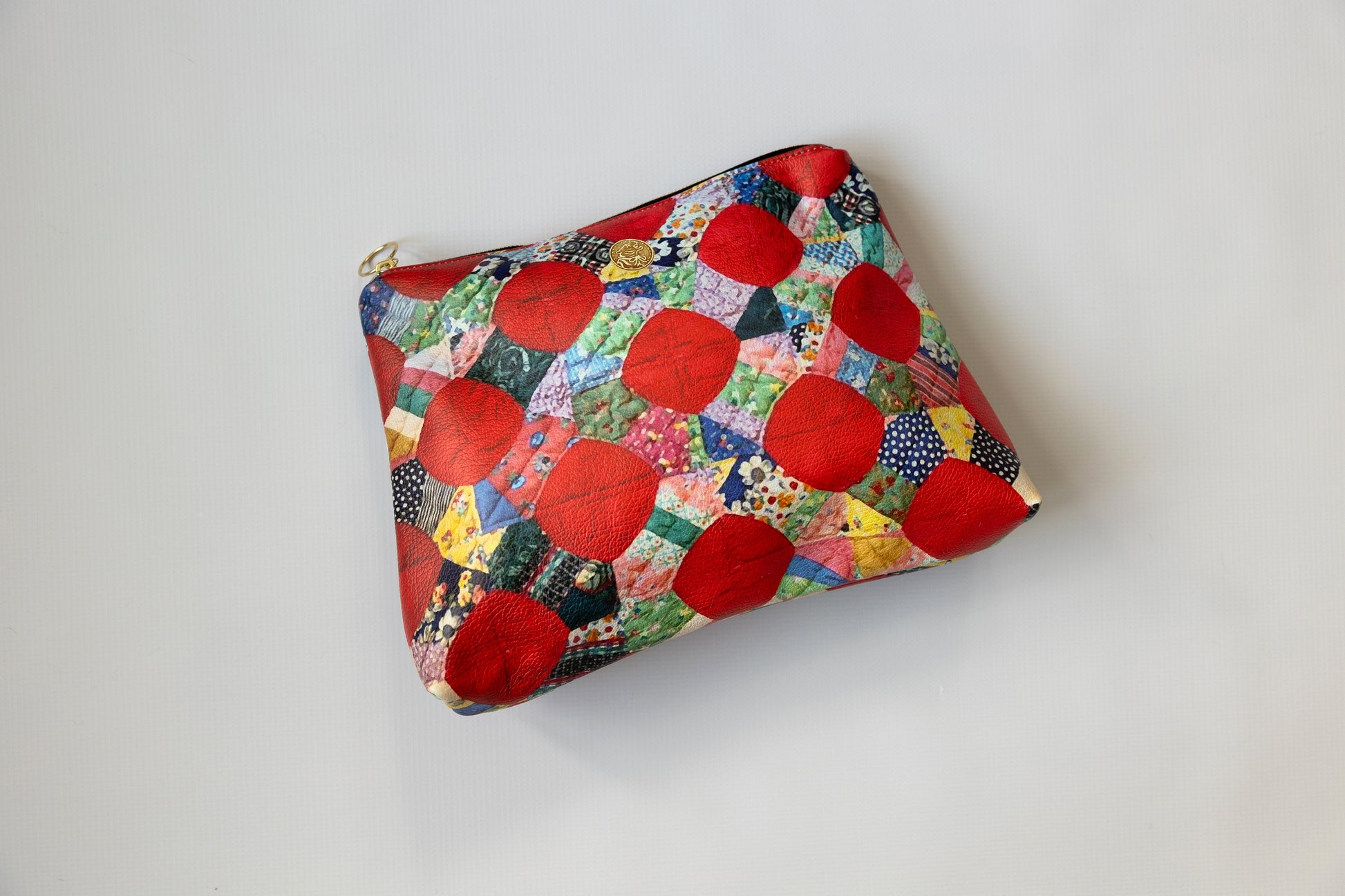 Colorful pouch with red geometric patterns on a white background