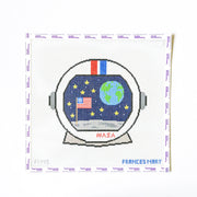 Needlepoint design of an astronaut helmet with NASA logo and American flag on a white background