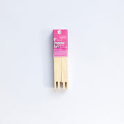 Packaged wooden stretcher bars with pink label on a white background