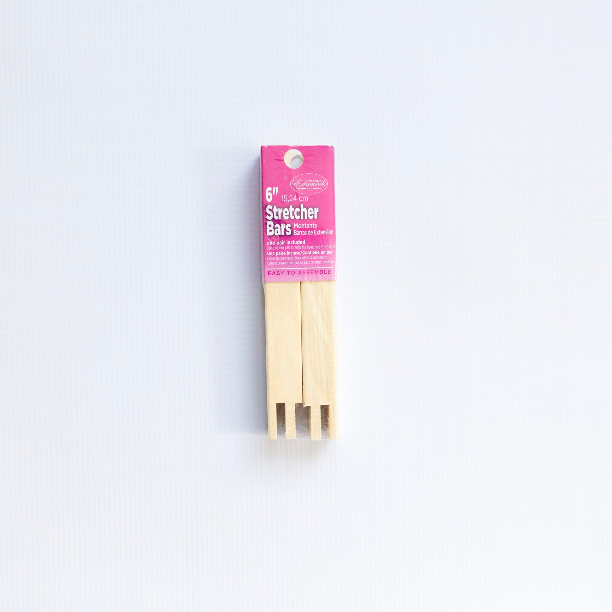 Packaged wooden stretcher bars with pink label on a white background