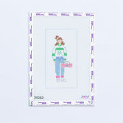 Needlepoint design of a person in jeans and green and white striped shirt holding a boom box on a white background with branding text.