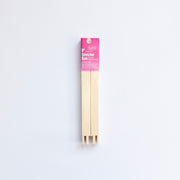 Packaged wooden stretcher bars with a pink label on a white background
