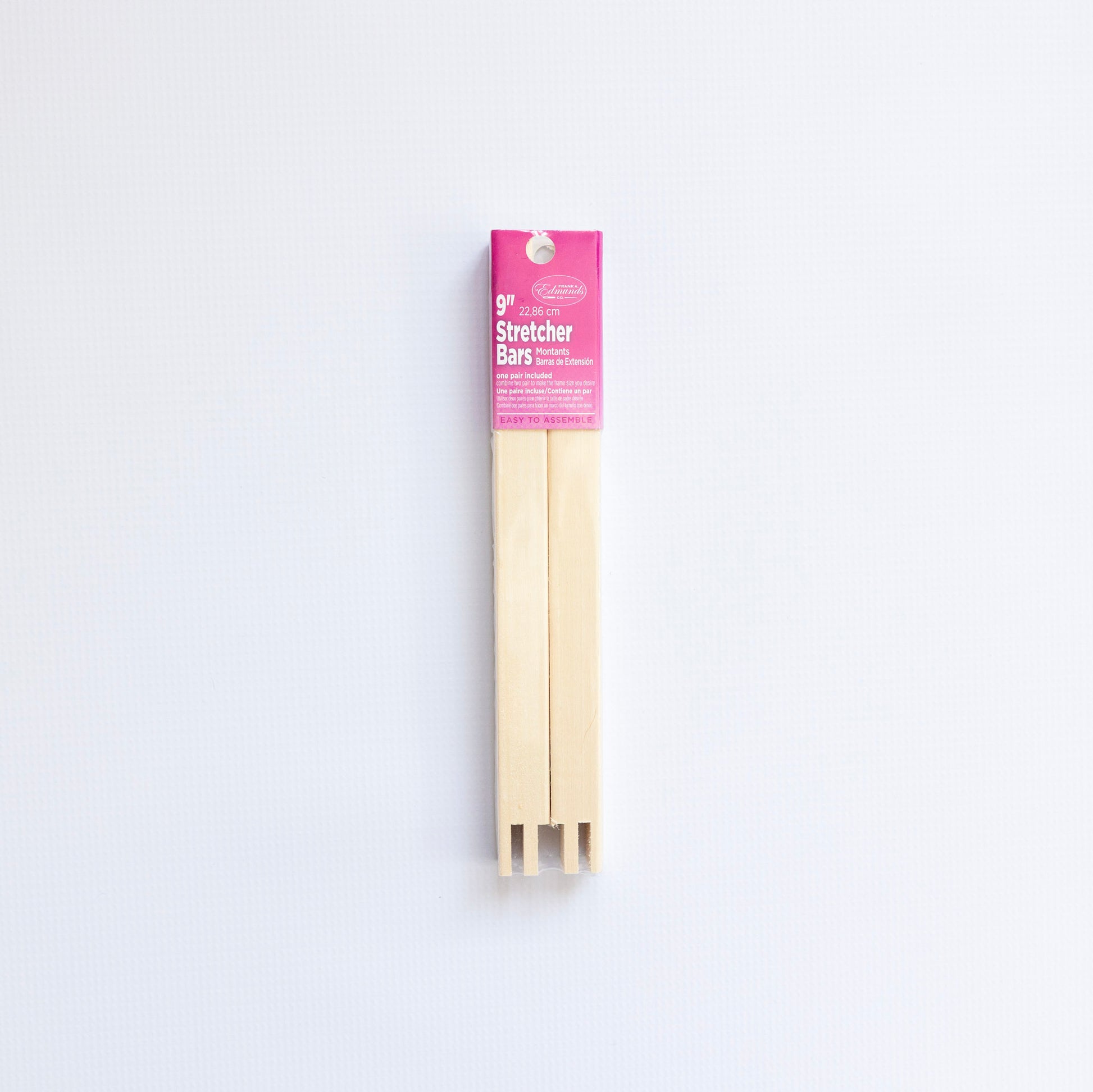 Packaged wooden stretcher bars with a pink label on a white background