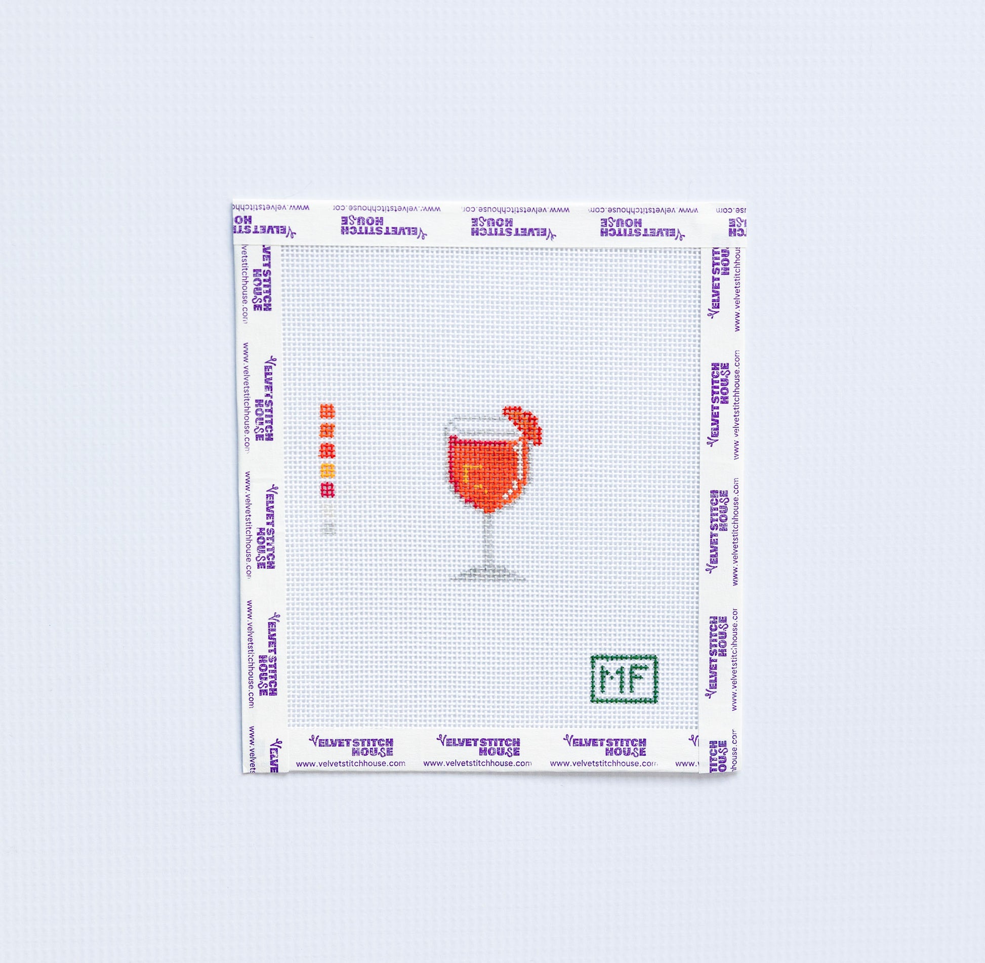 mini needlepoint pattern with orange aperol spritz on white background