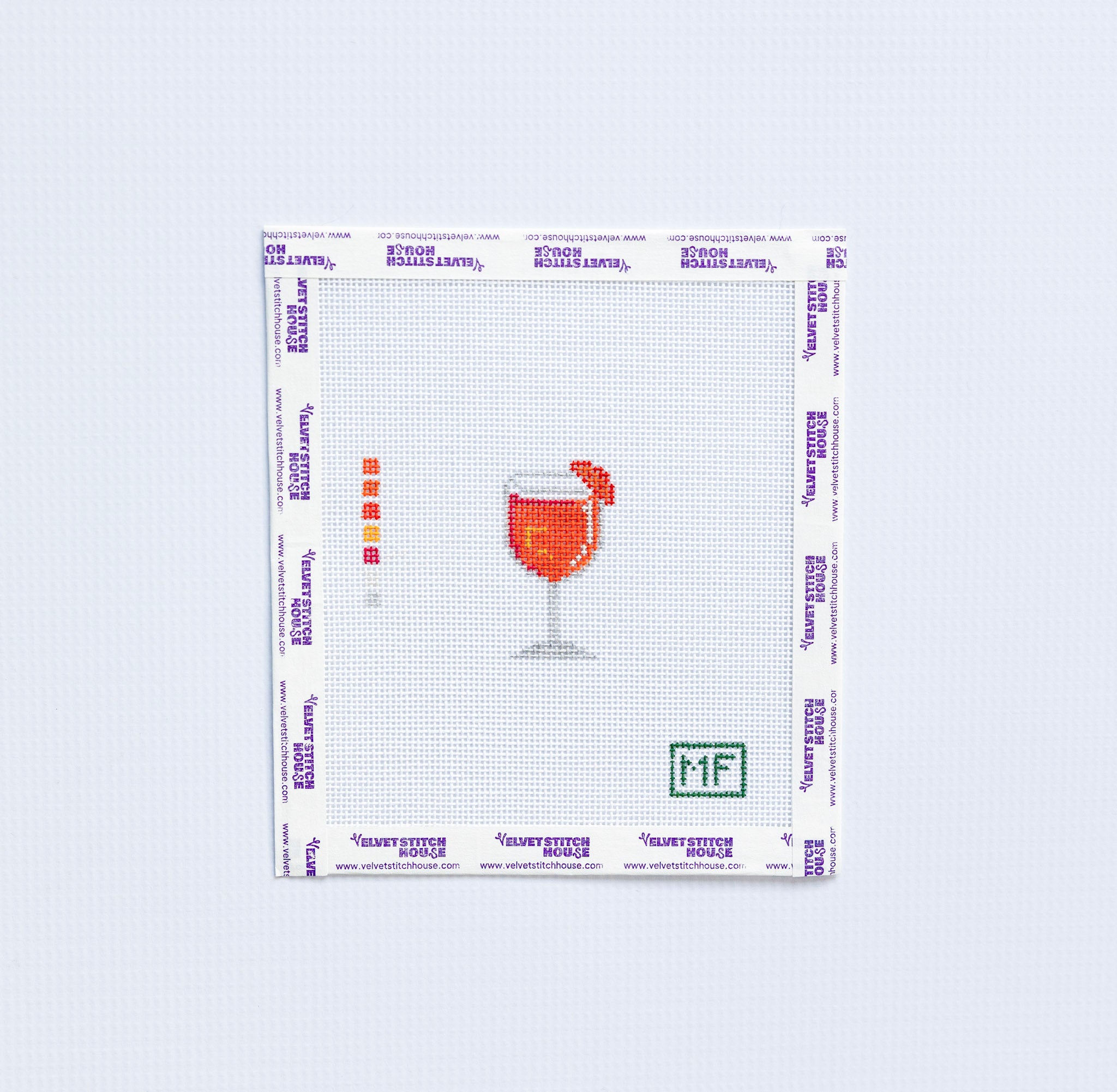 mini needlepoint pattern with orange aperol spritz on white background