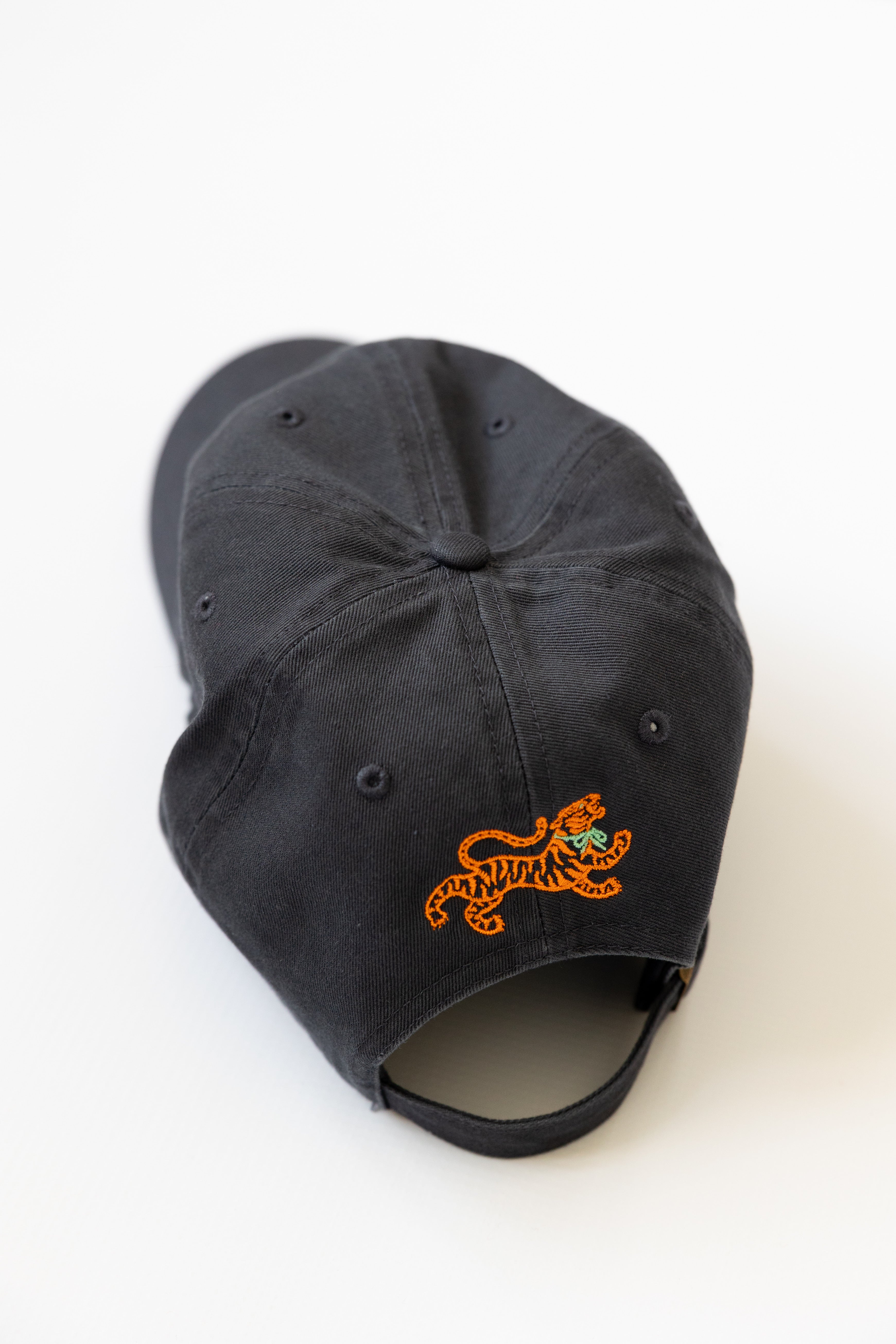 Navy cap with orange tiger logo on a white background