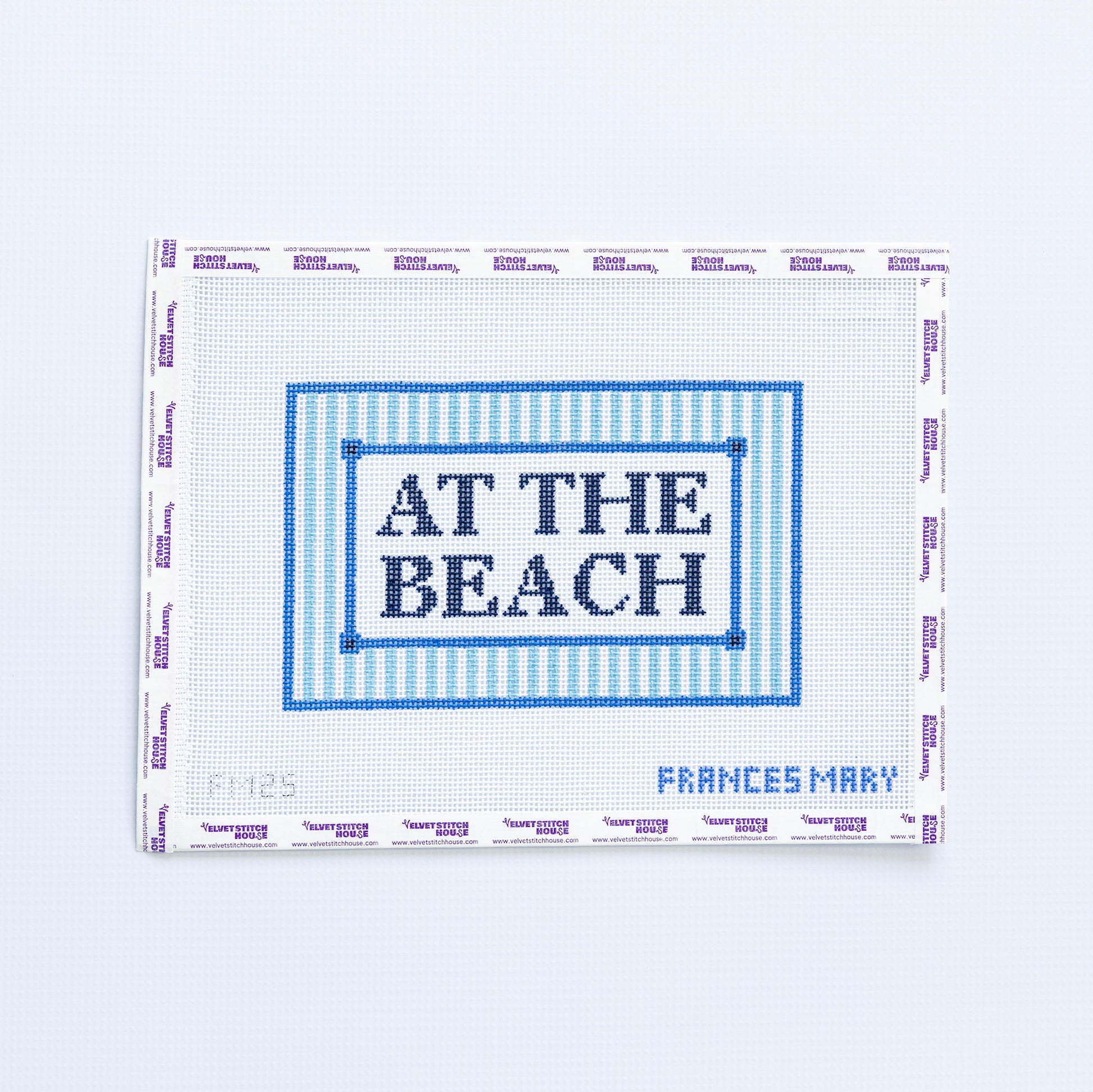 Needlepoint pattern with 'At the Beach' text in navy blue on a white background
