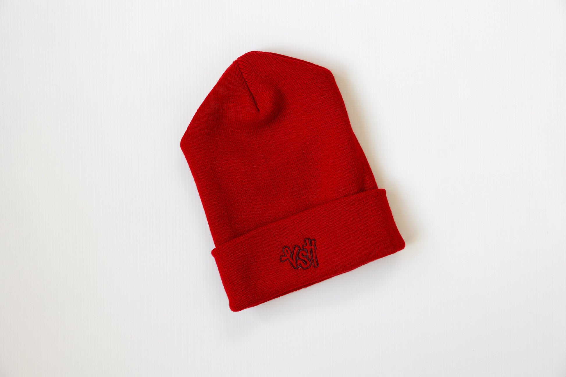 Red beanie with velvet stitch house logo