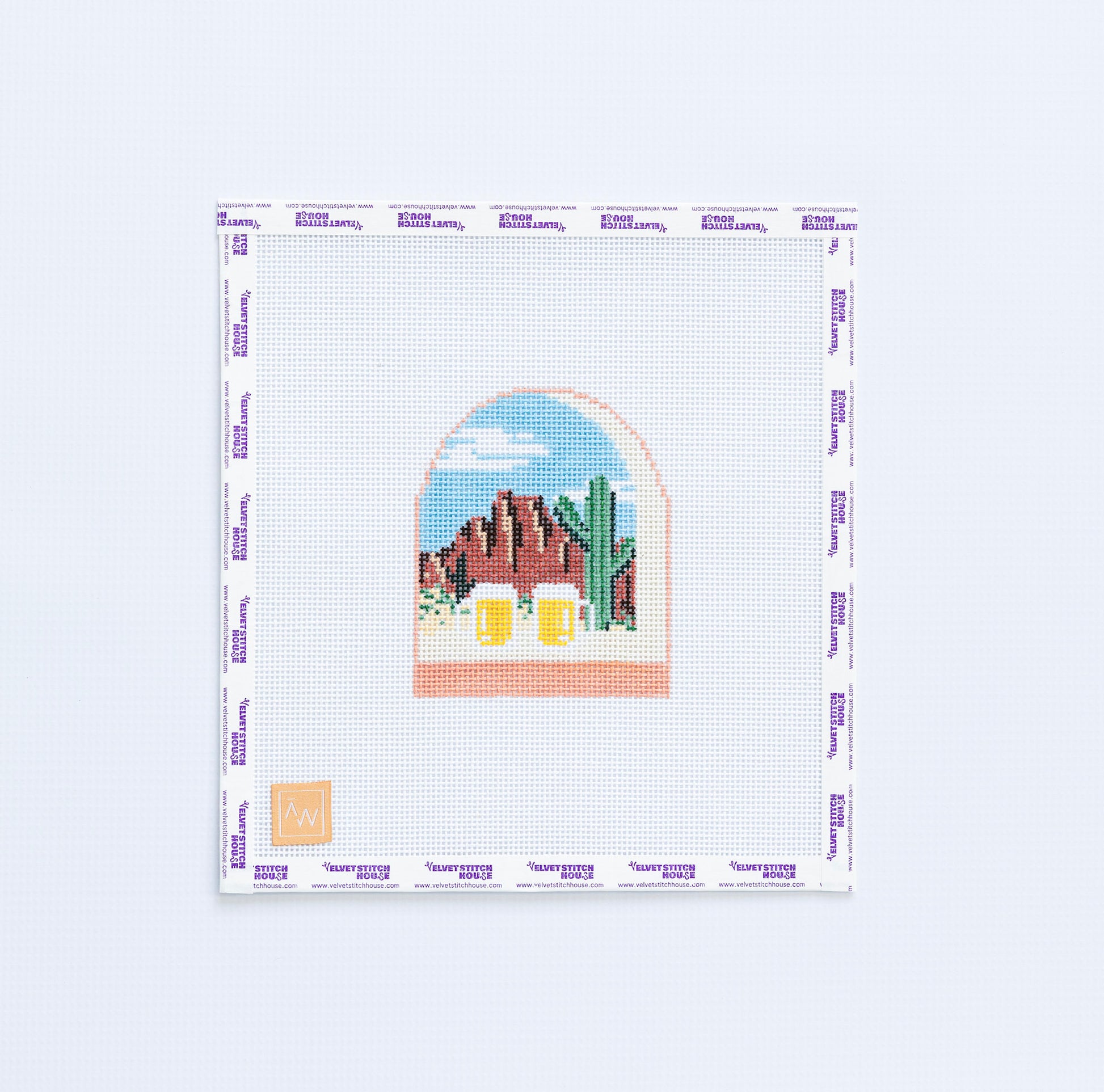 Needlepoint design of landscape with mountains and cacti and two beer mugs.