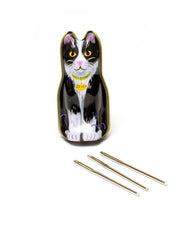 Cat-shaped knitting needle case with three needles on a white background