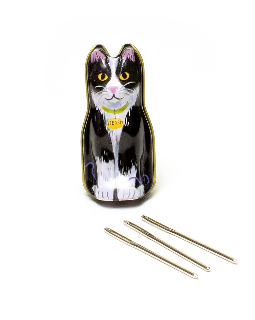 Cat-shaped knitting needle case with three needles on a white background