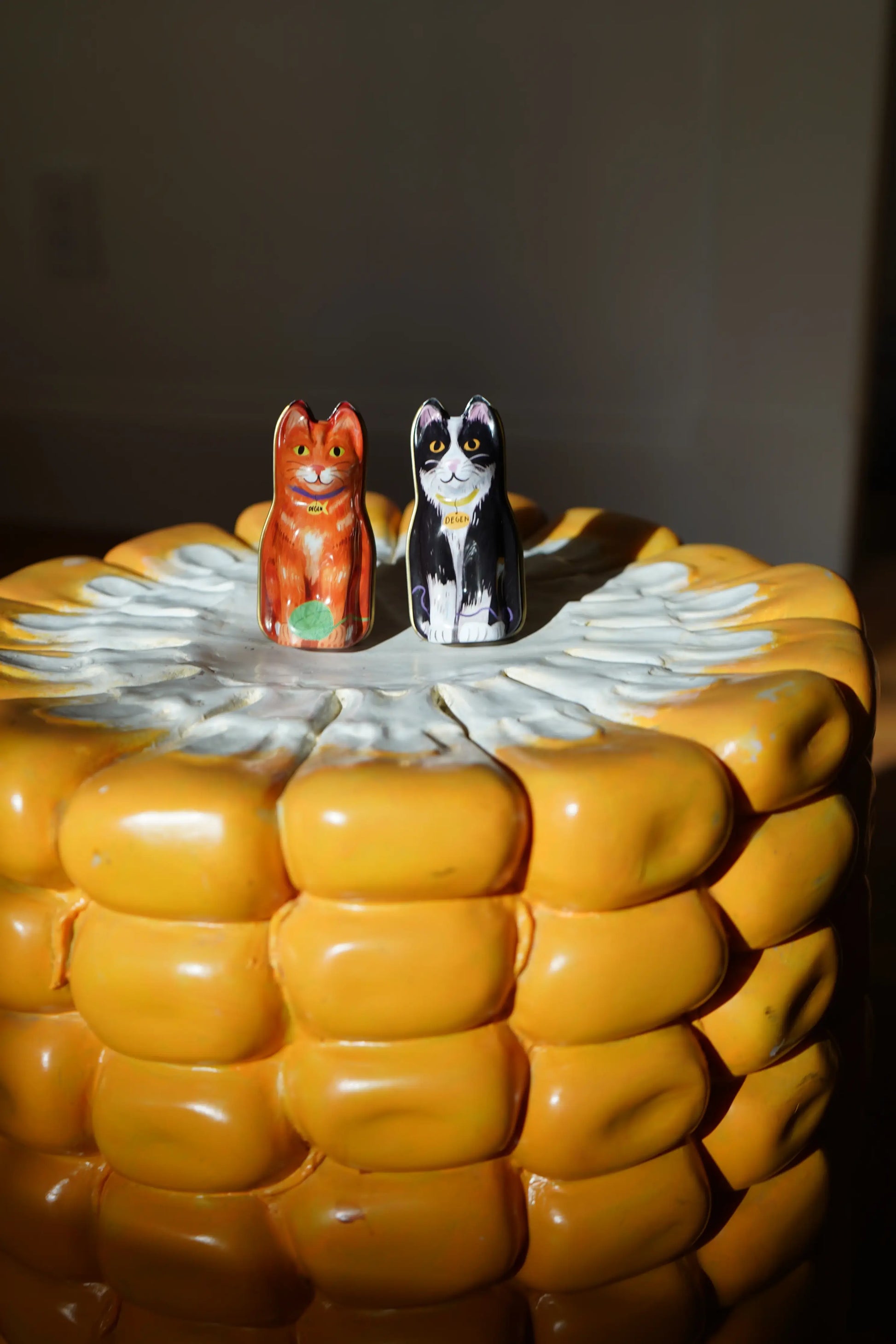 cat-shaped tin holder on top of a table