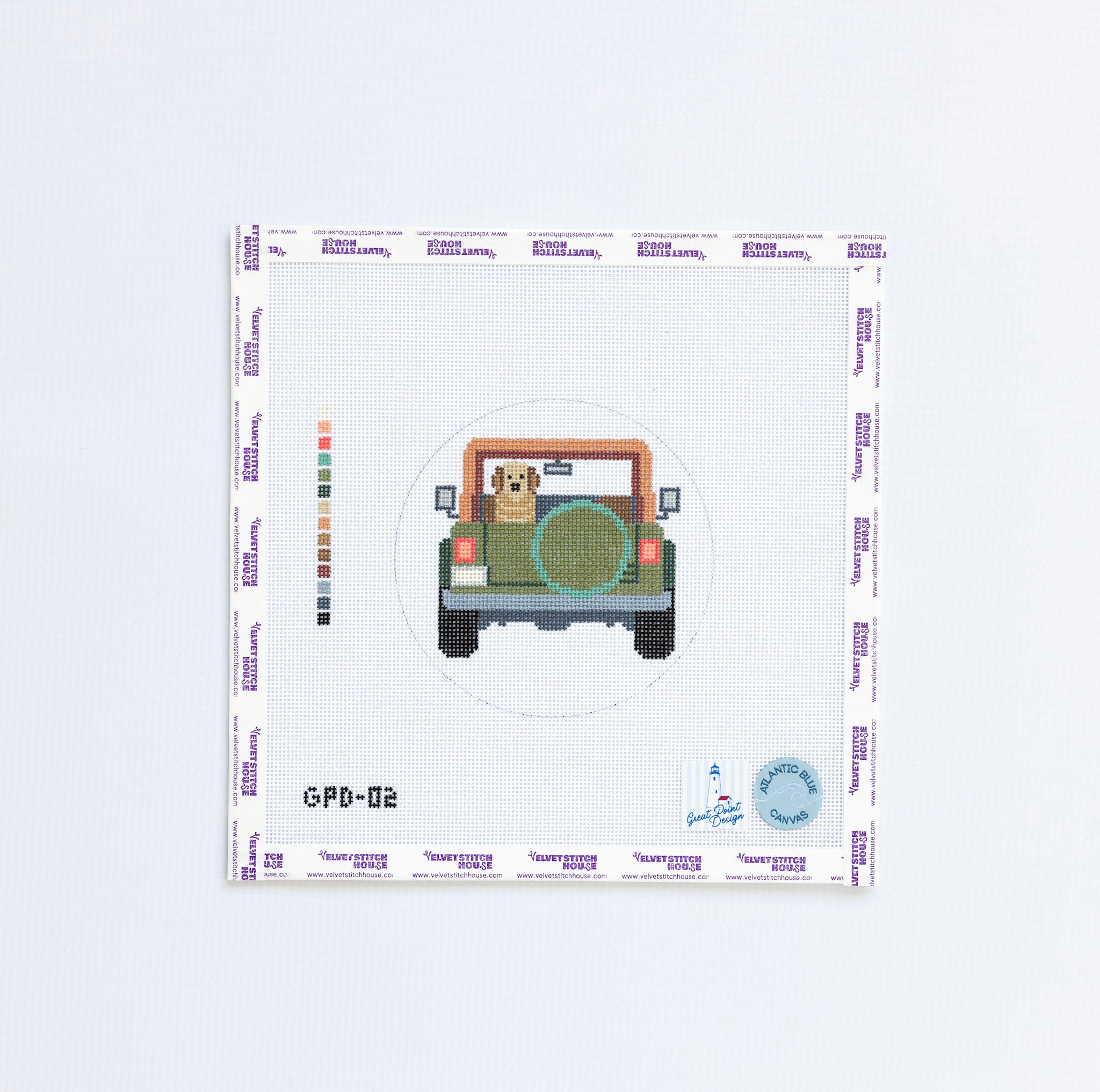 Needlepoint pattern with a green jeep and dog looking out of the back.
