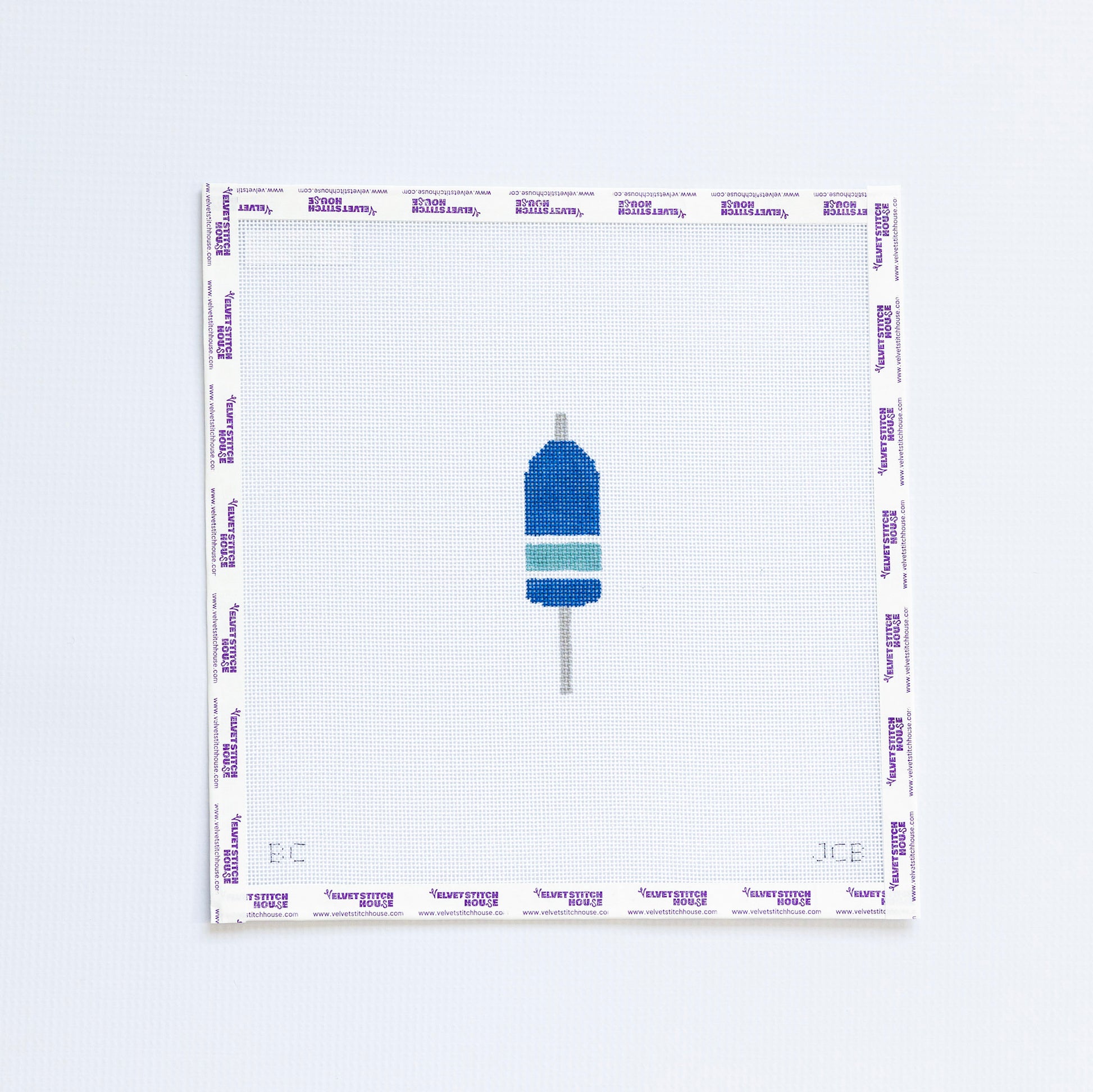 Needlepoint design of a blue and green striped buoy on a white background