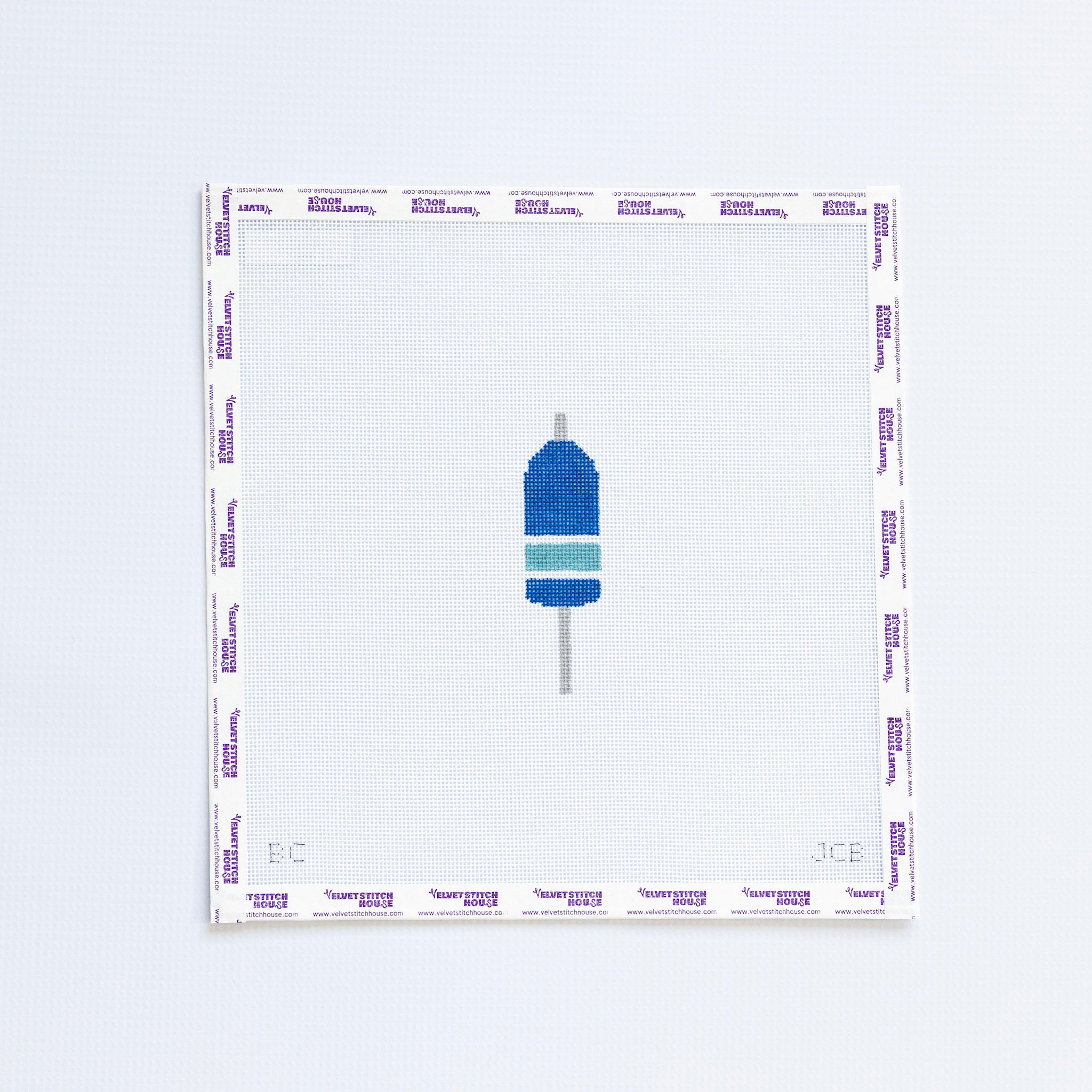 Needlepoint design of a blue and green striped buoy on a white background