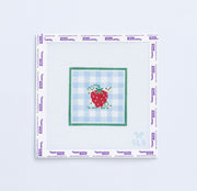 Needlepoint pattern of a strawberry design on a light blue gingham design and green border