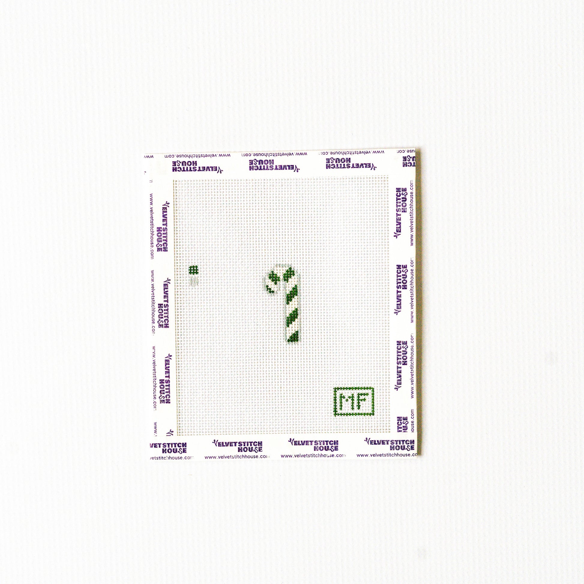 Needlepoint pattern with a green and white striped mini candy cane.