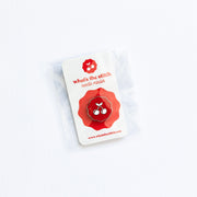 Red and white needle minder with 'What's the Stitch' cherry branding on a white background