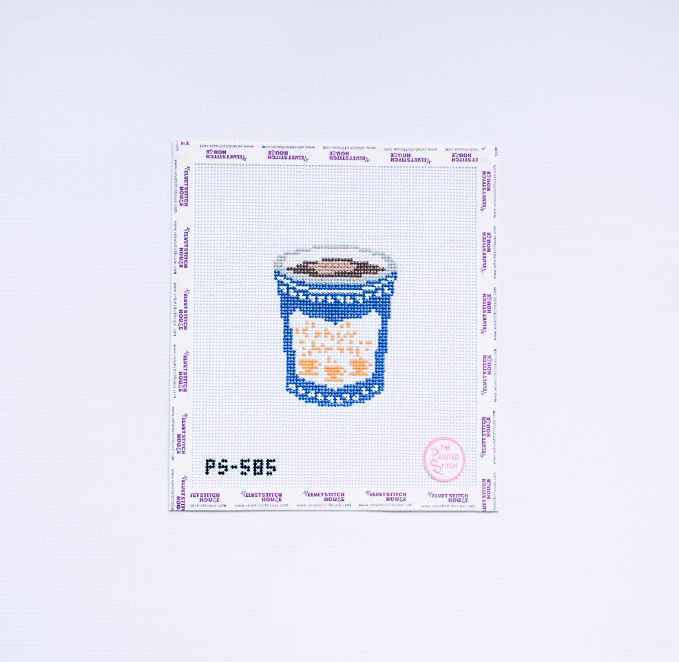 Needlepoint design of a classic coffee cup with blue and white detail.