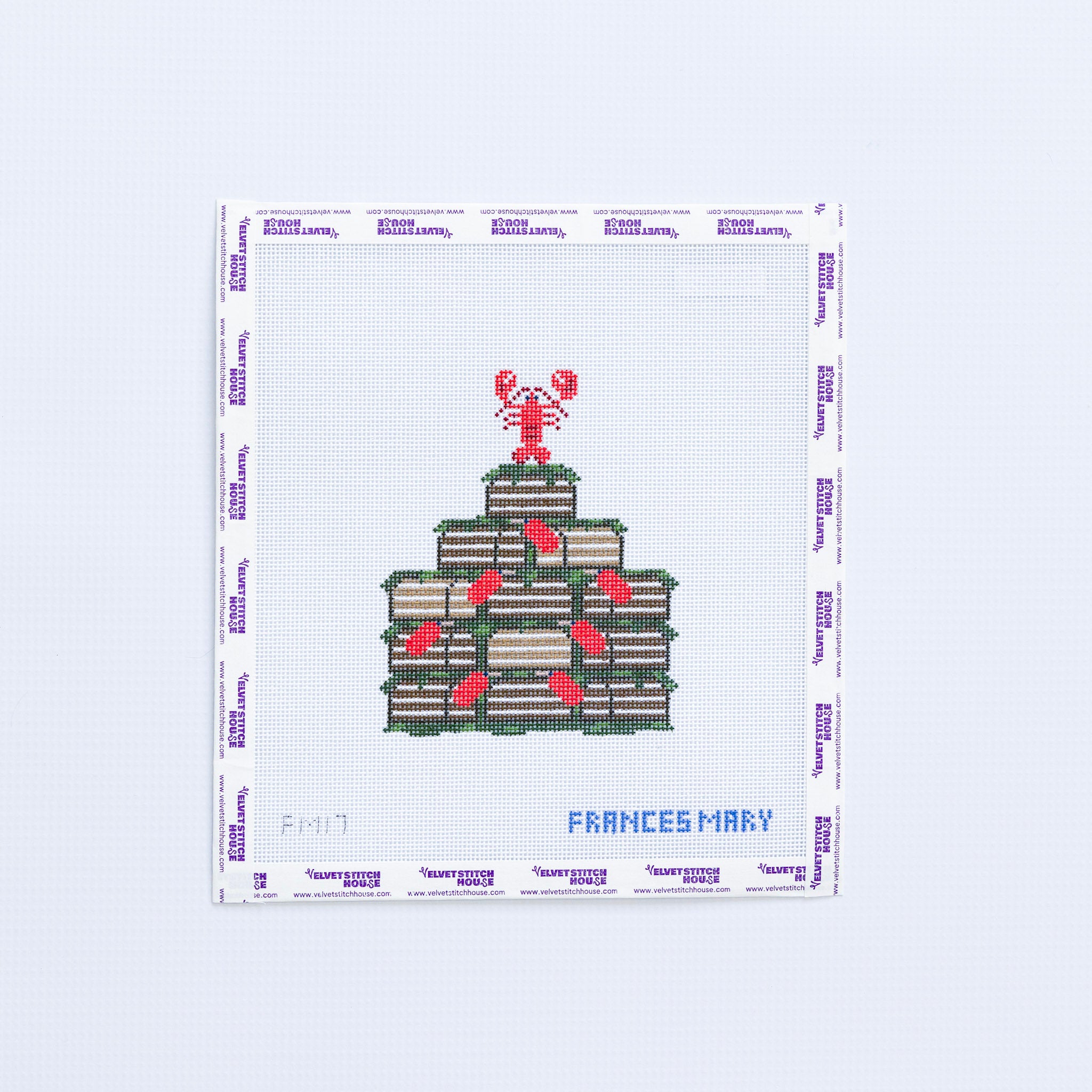 Needlepoint design of crates with a lobster on top, labeled 'Frances Mary'.
