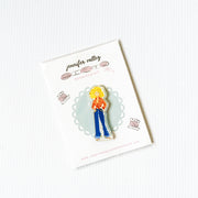 Needleminder magnet of a person with blonde hair and blue bell bottom pants