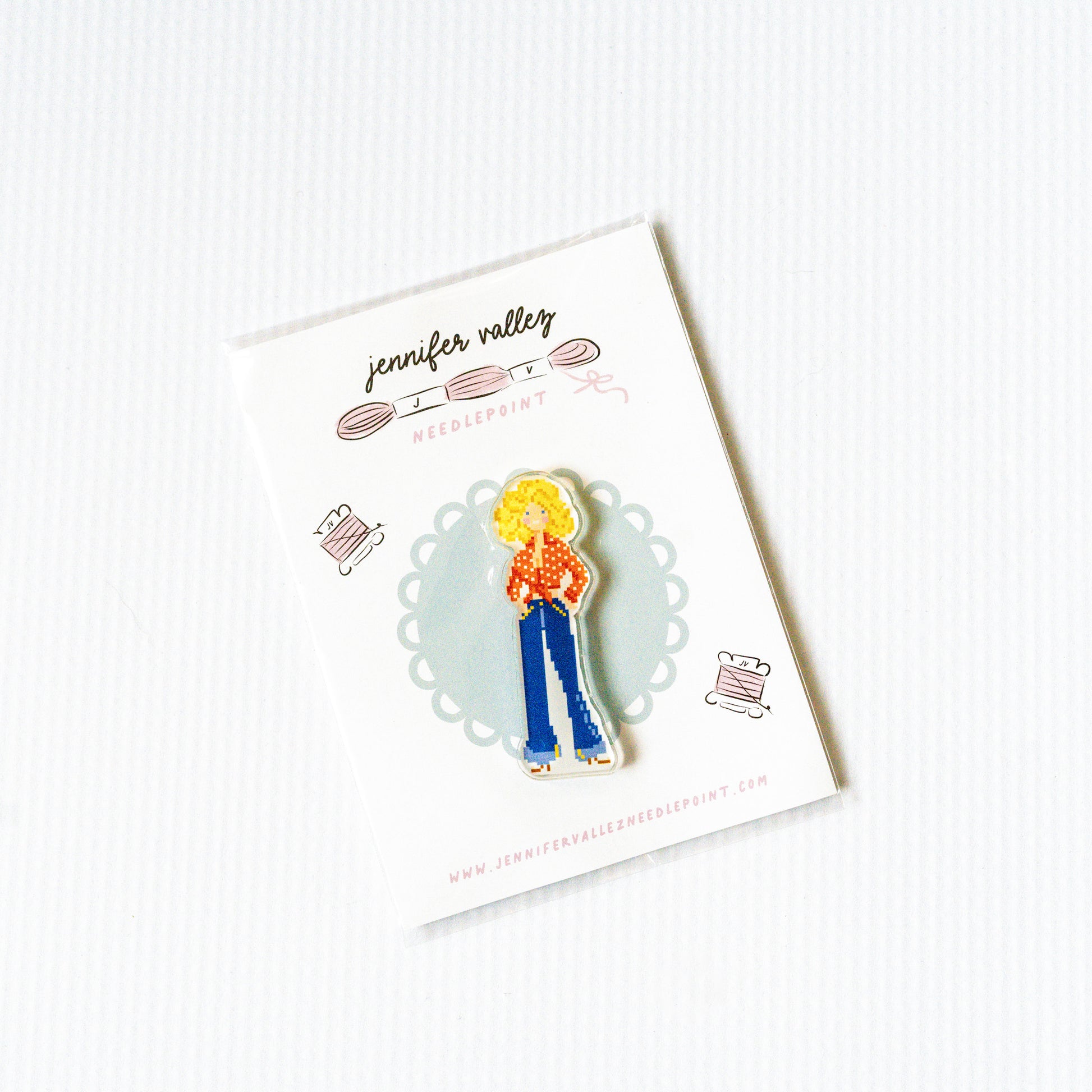 Needleminder magnet of a person with blonde hair and blue bell bottom pants