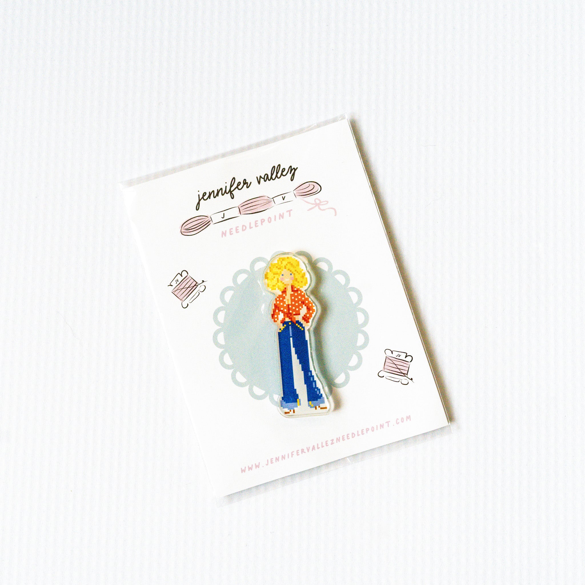 Needleminder magnet of a person with blonde hair and blue bell bottom pants