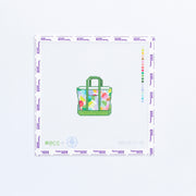 Needlepoint design of a geometric tote bag in mulit colors with green trim