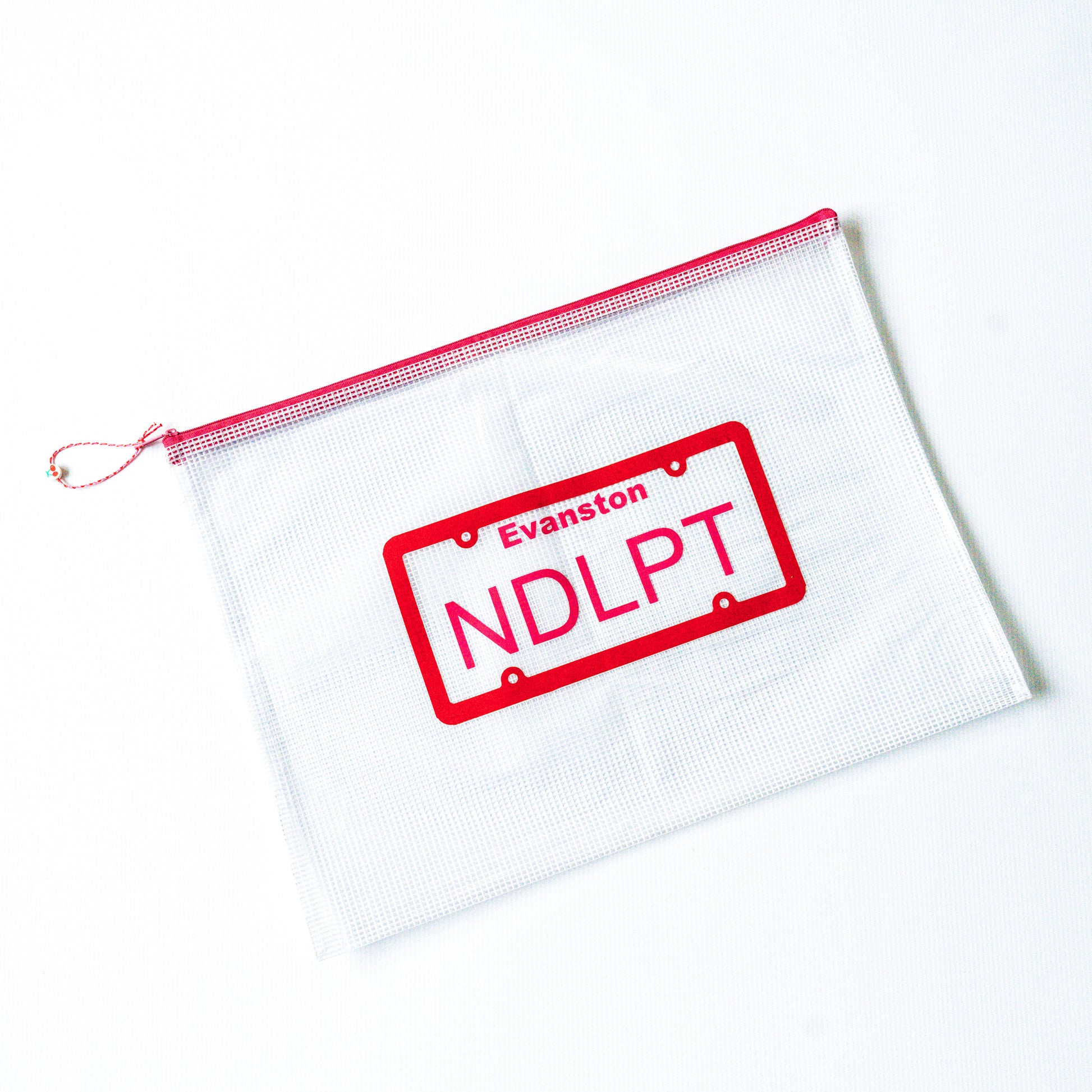 White pouch with red zipper and 'Evanston NDLPT' stamp on a white background