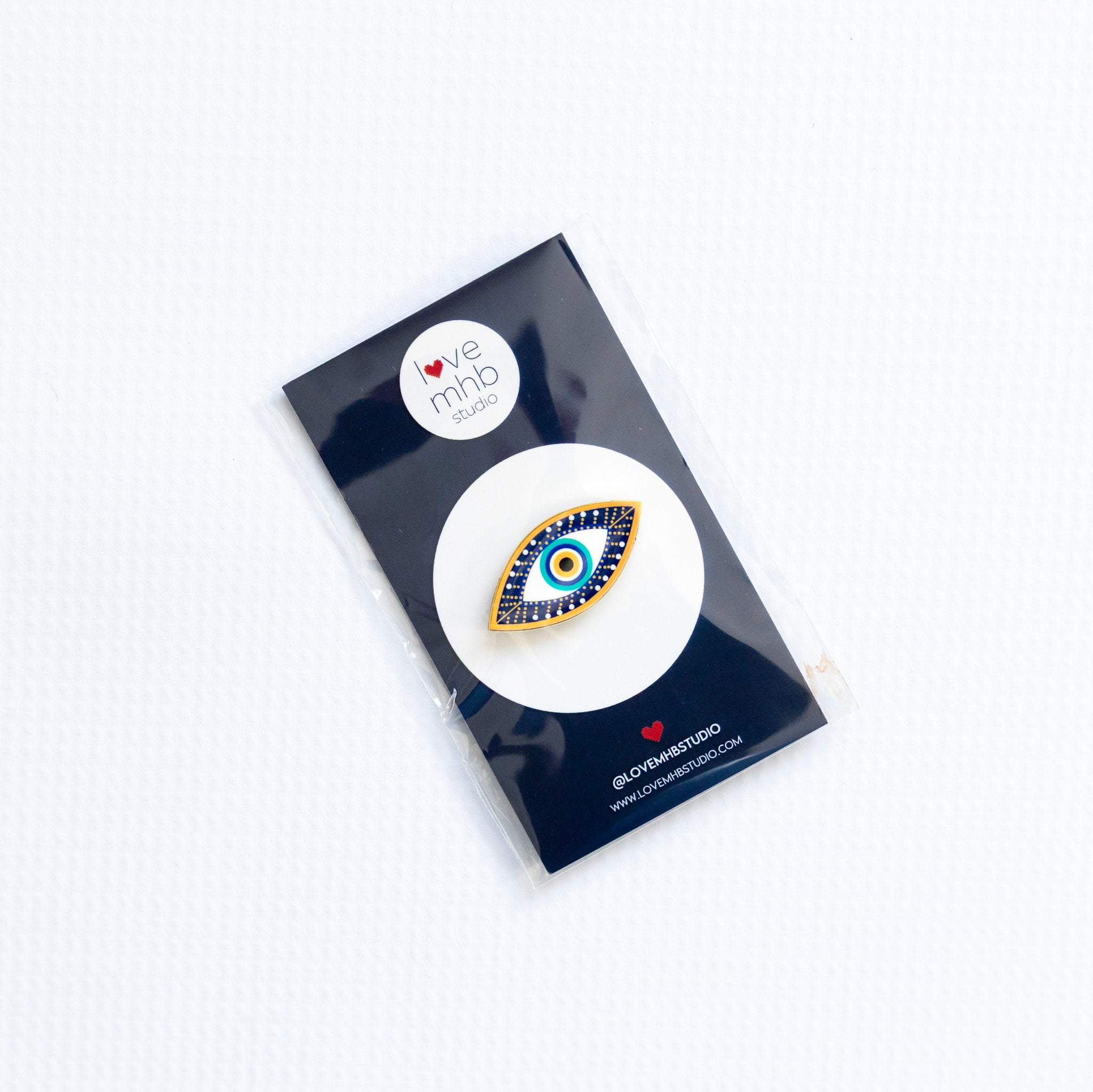 Needleminder with an evil eye design on a white background