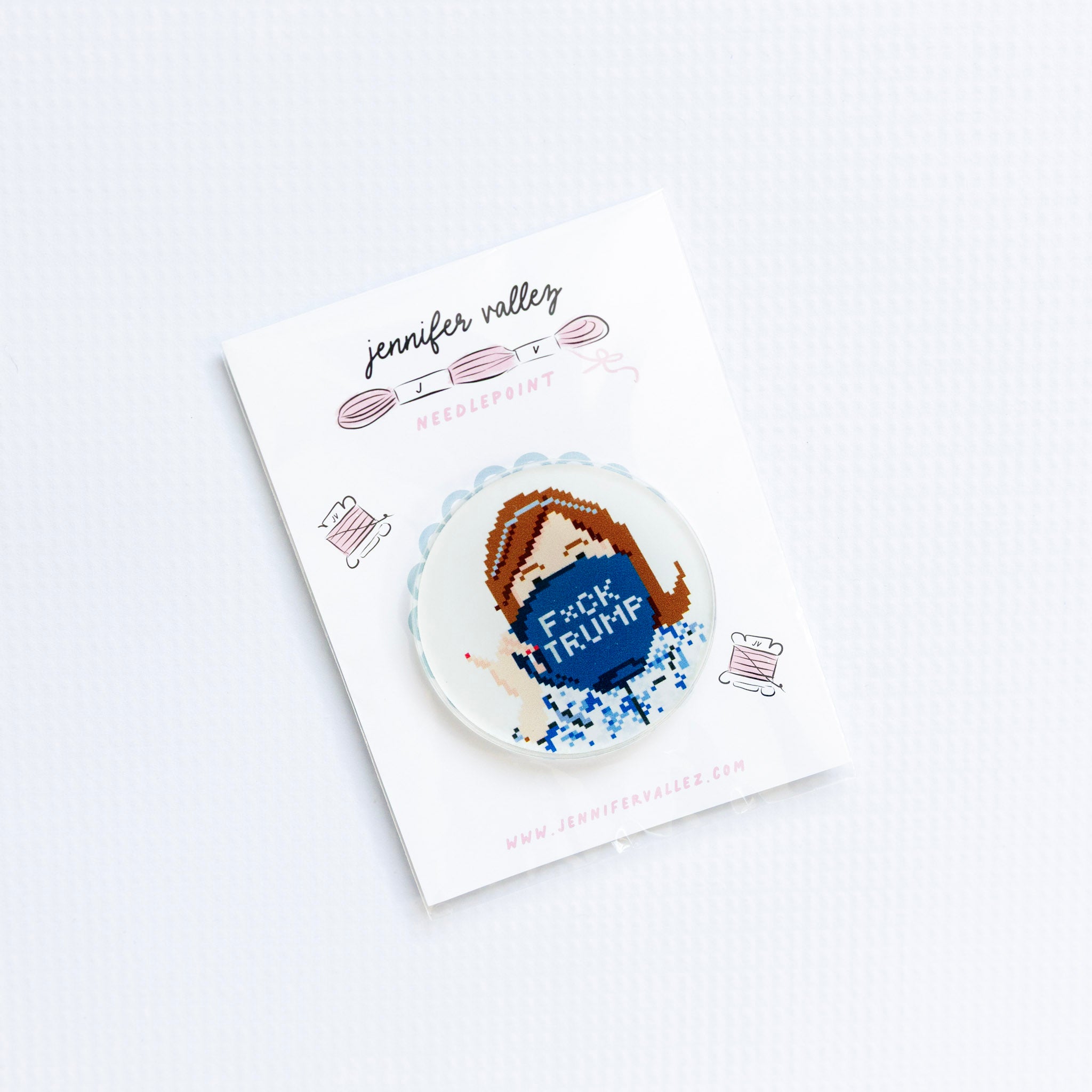 Needleminder Button badge with 'F*ck Trump' text on a card.