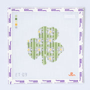 Needlepoint pattern for a shamrock with flowers on a white background