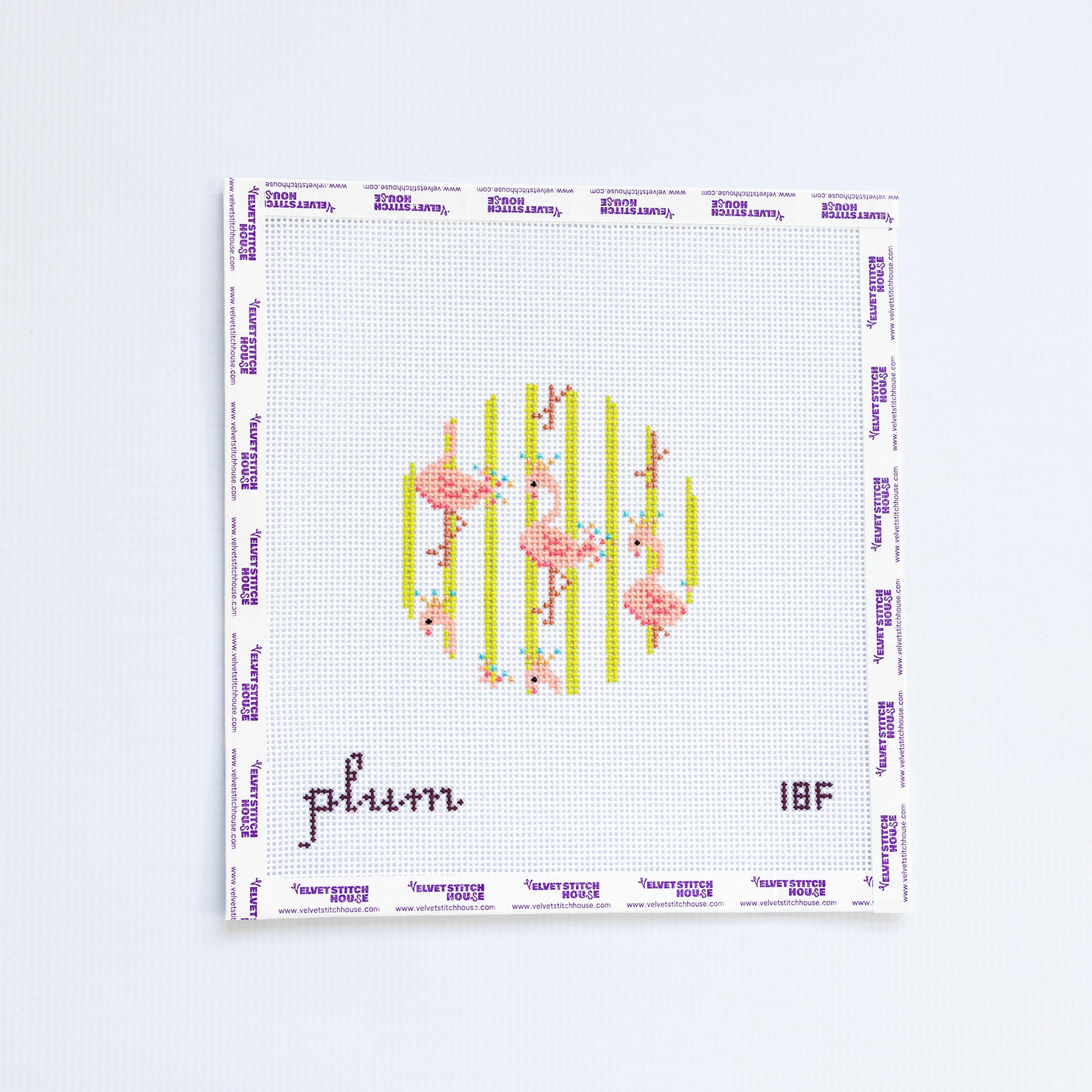 Needlepoint round design with pink flamingos and green striped background