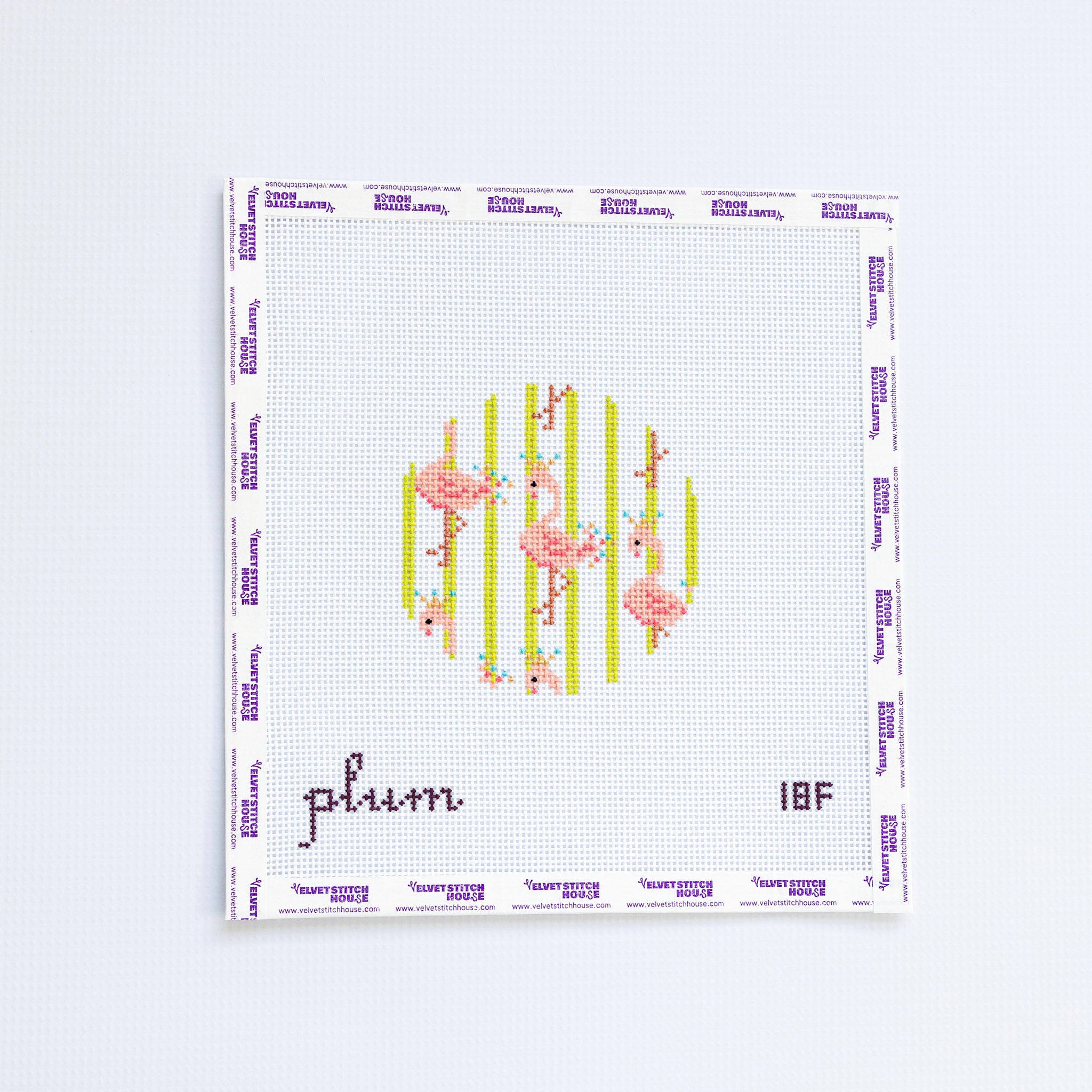 Needlepoint round design with pink flamingos and green striped background