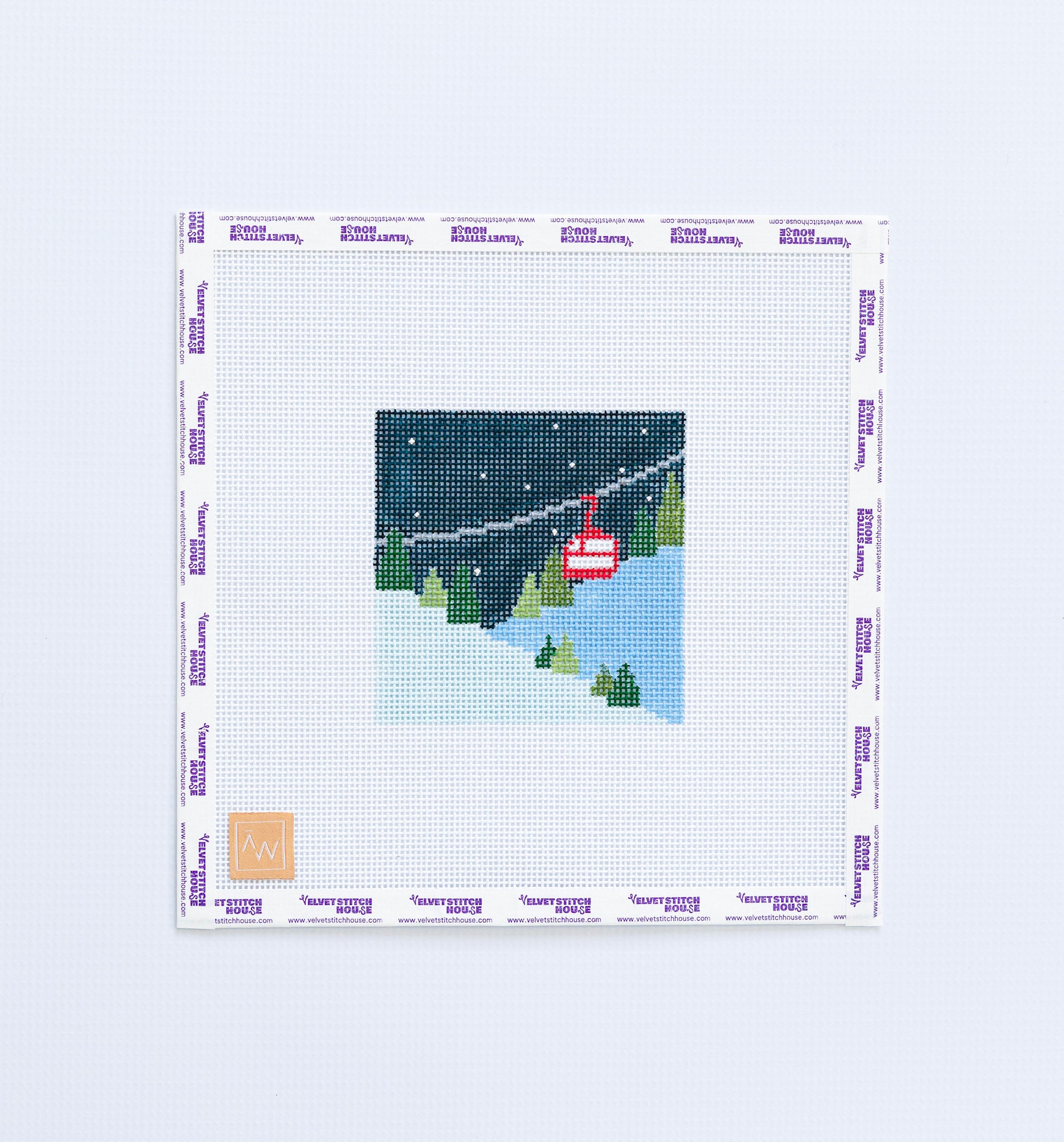 Needlepoint pattern of a red ski lift with trees and mountain in the background.