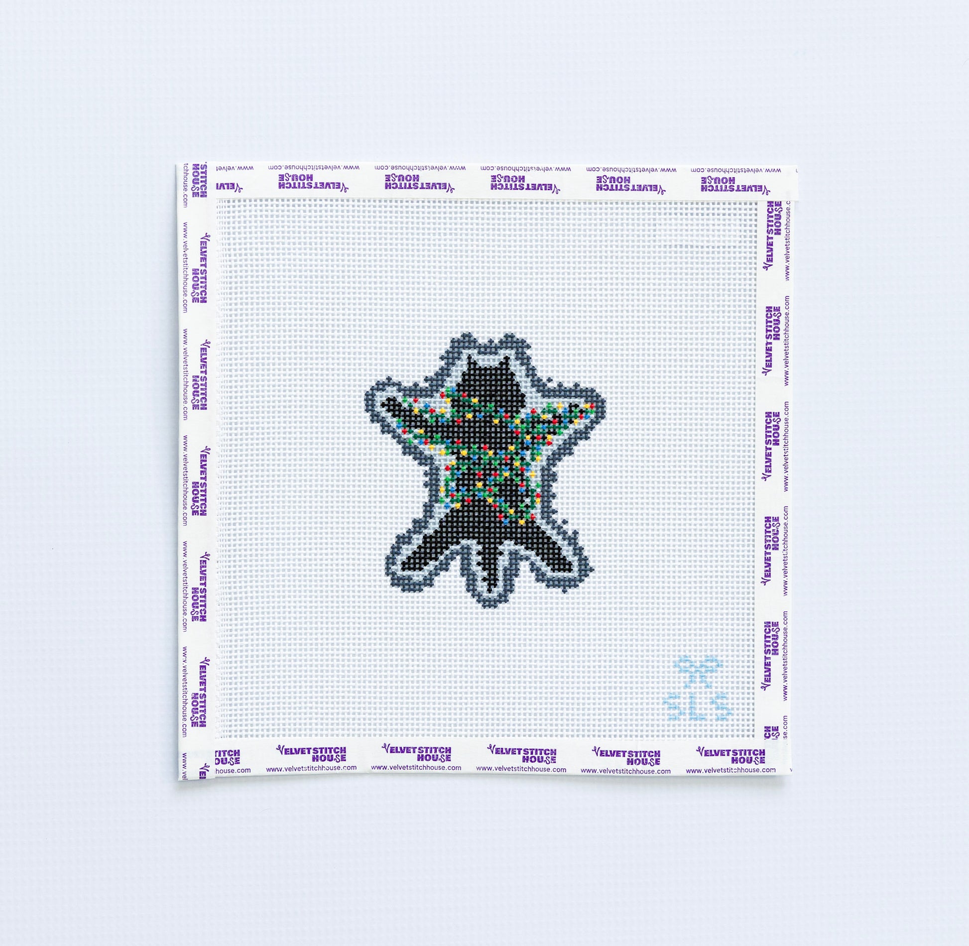 Needlepoint pattern of a black cat with  multicolored christmas lights 