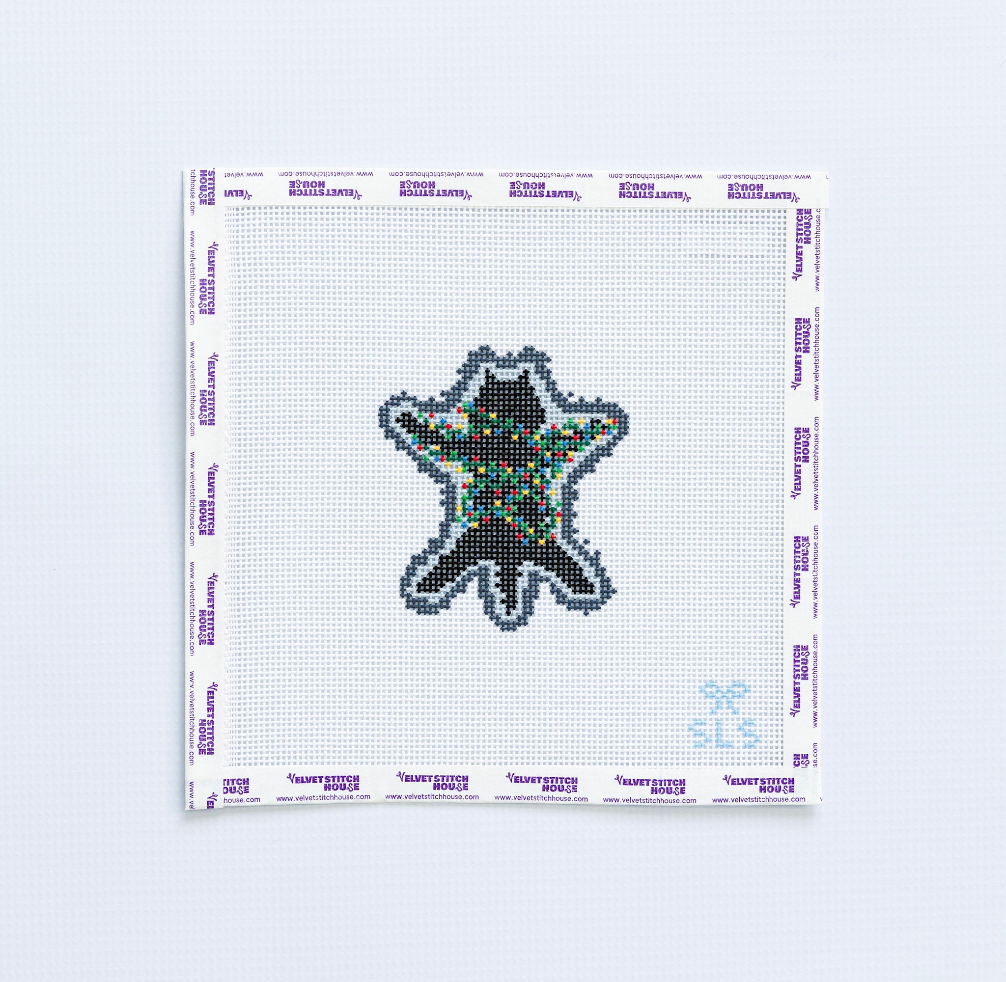 Needlepoint pattern of a black cat with  multicolored christmas lights 