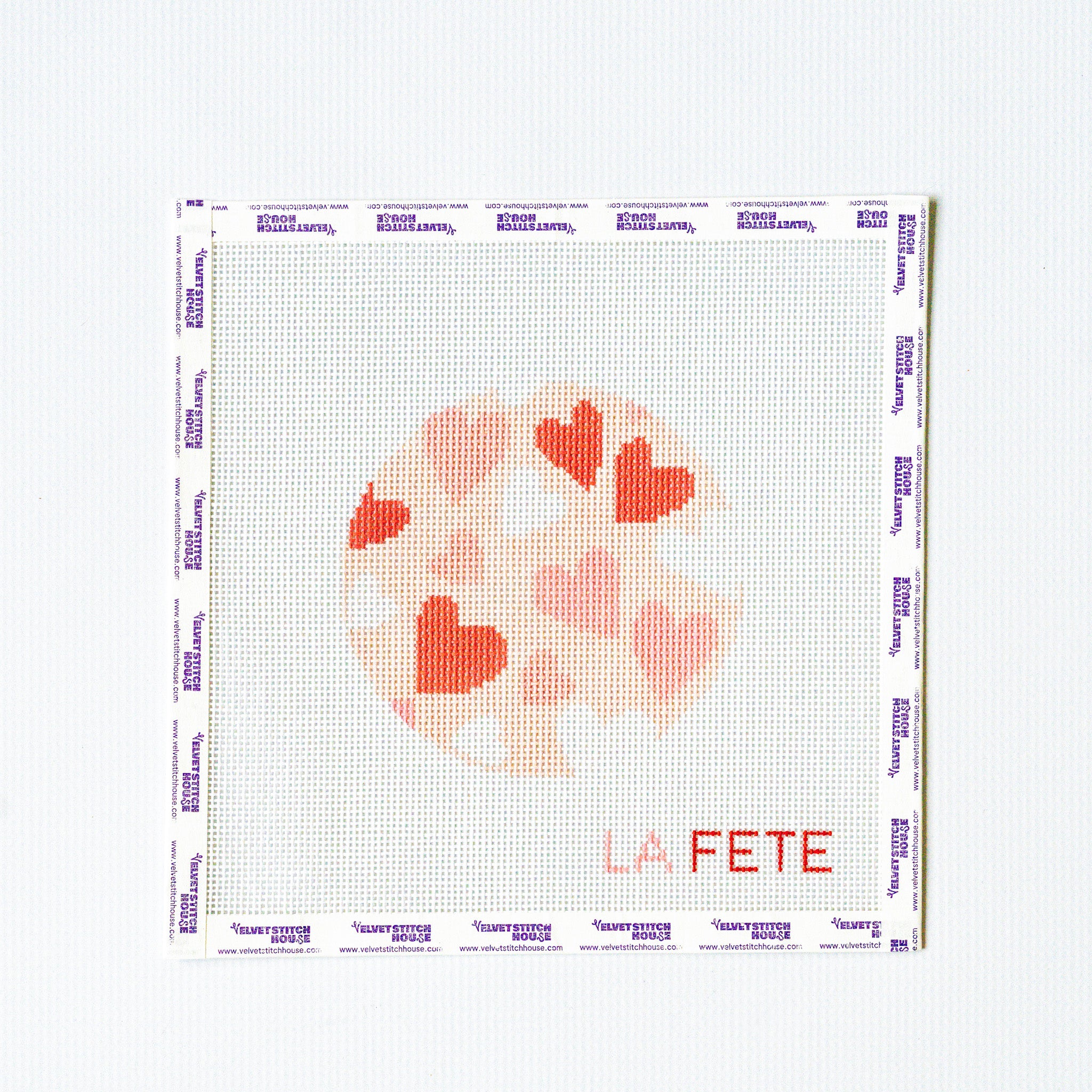 Needlepoint pattern with round heart design on a white background