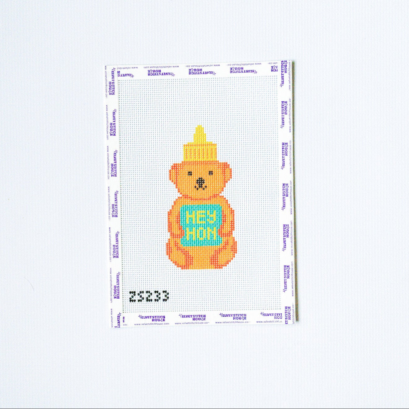 Needlepoint design with Colorful teddy bear with a 'Hey Hon' sign on a white background