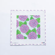 Needlepoint pattern with pink and purple flowers and green leaves on a white background