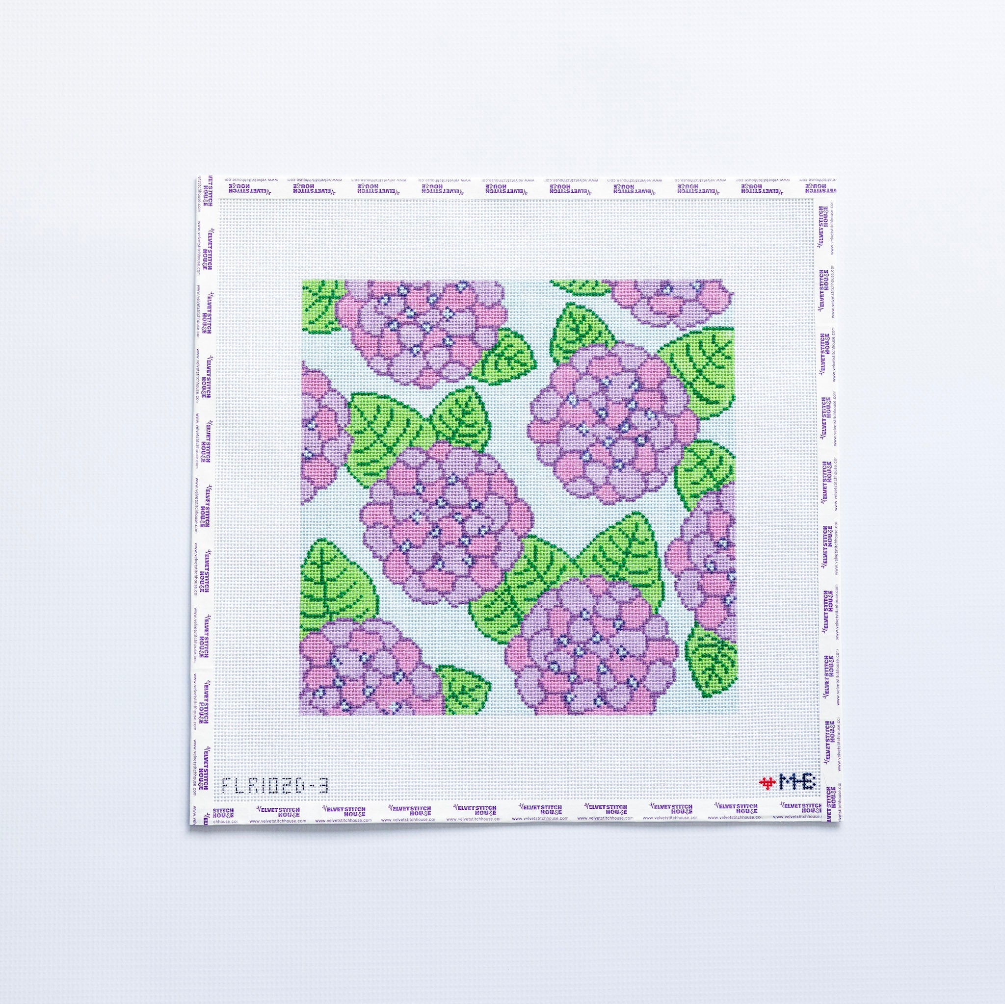 Needlepoint pattern with pink and purple flowers and green leaves on a white background
