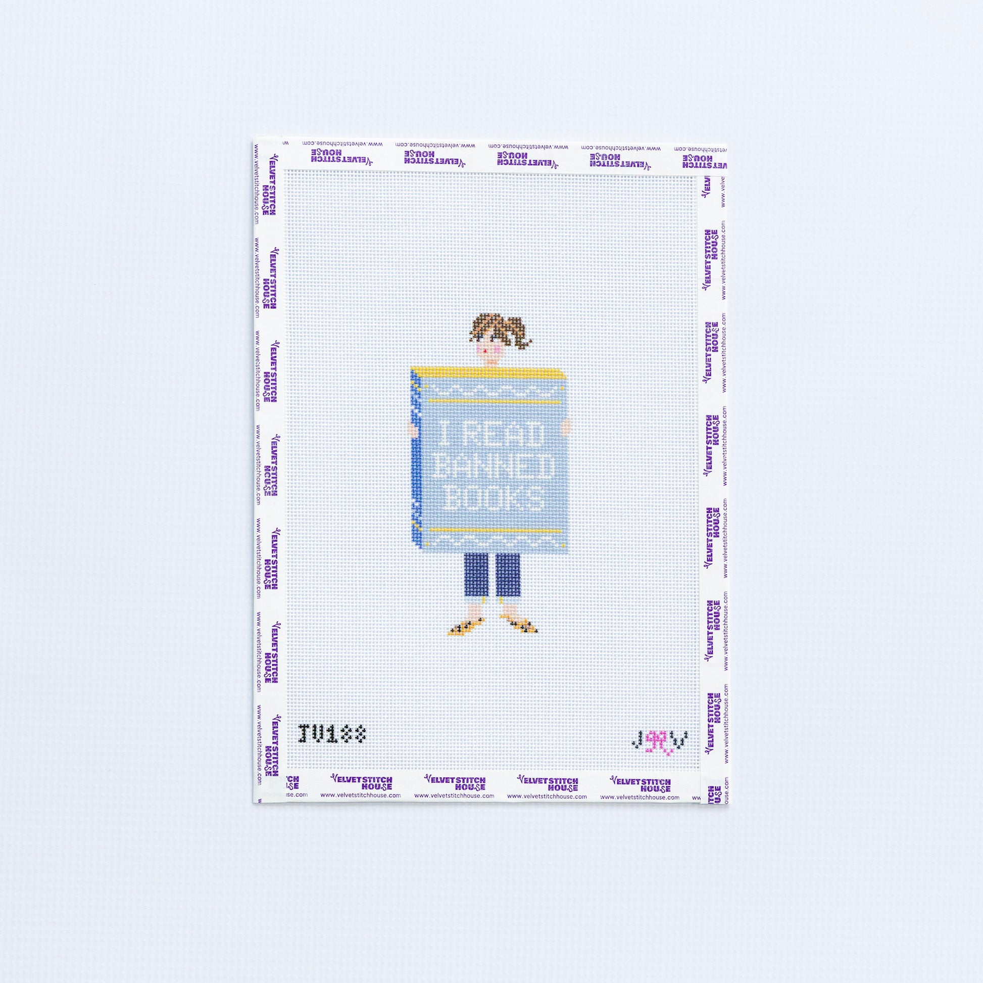 Needlepoint design of a person holding a book titled 'I Read Banned Books' on a white background