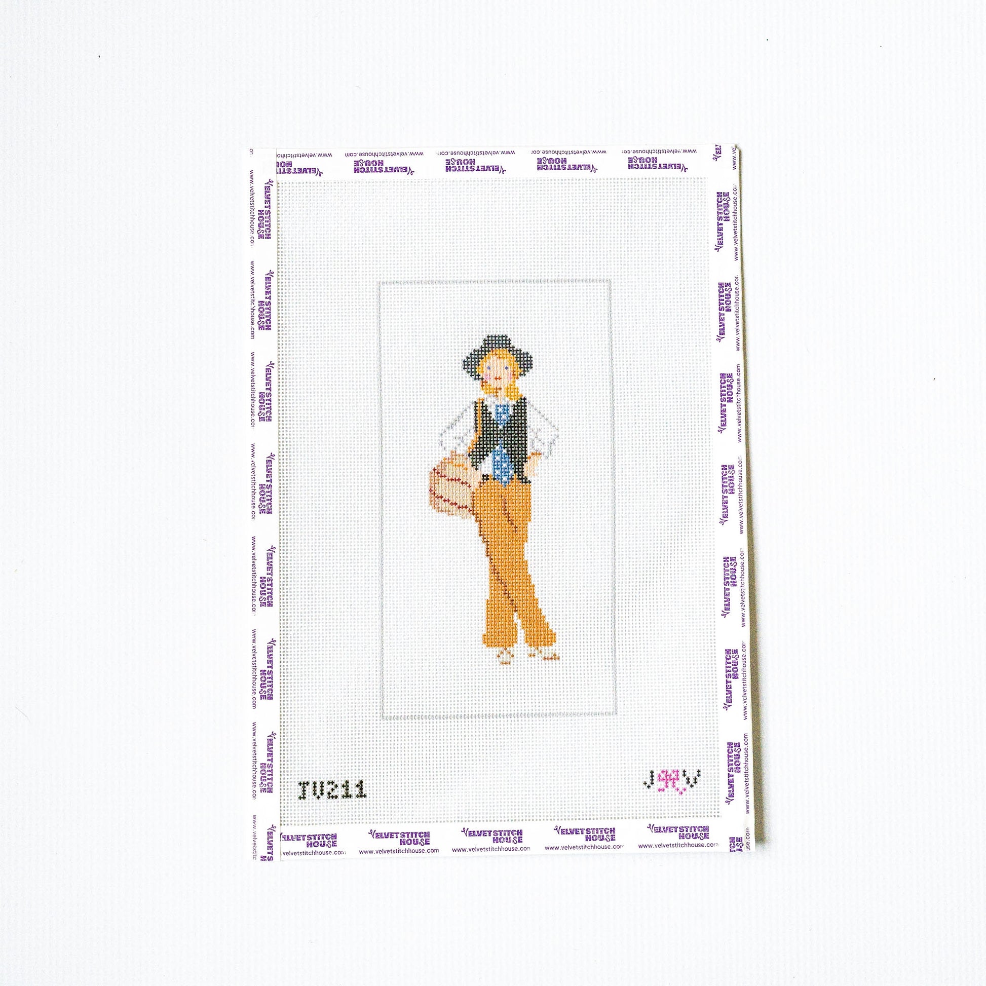 Needlepoint design of a person with a hat and vest on a white background