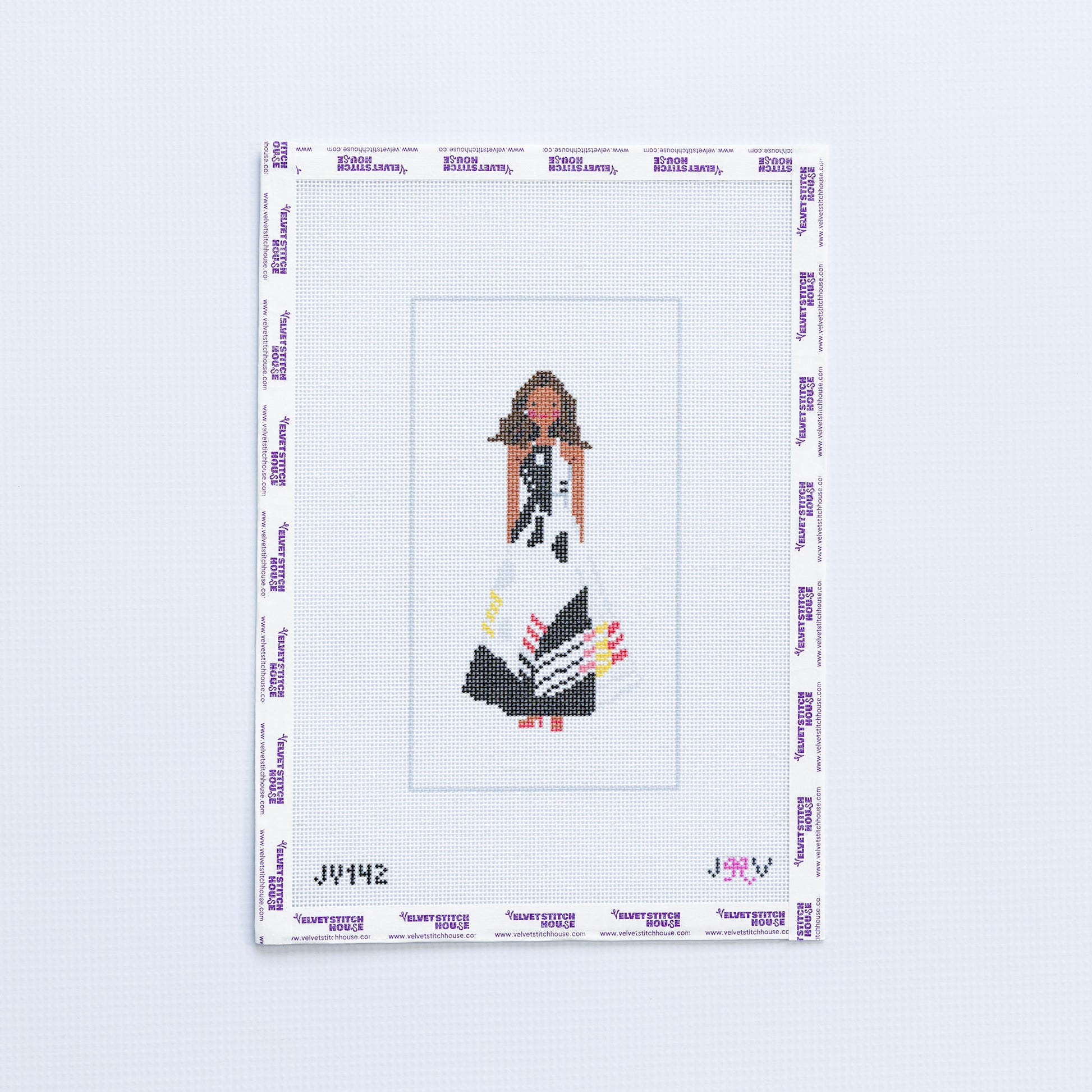 Needlepoint design of a woman Michelle Obama in a black and white dress