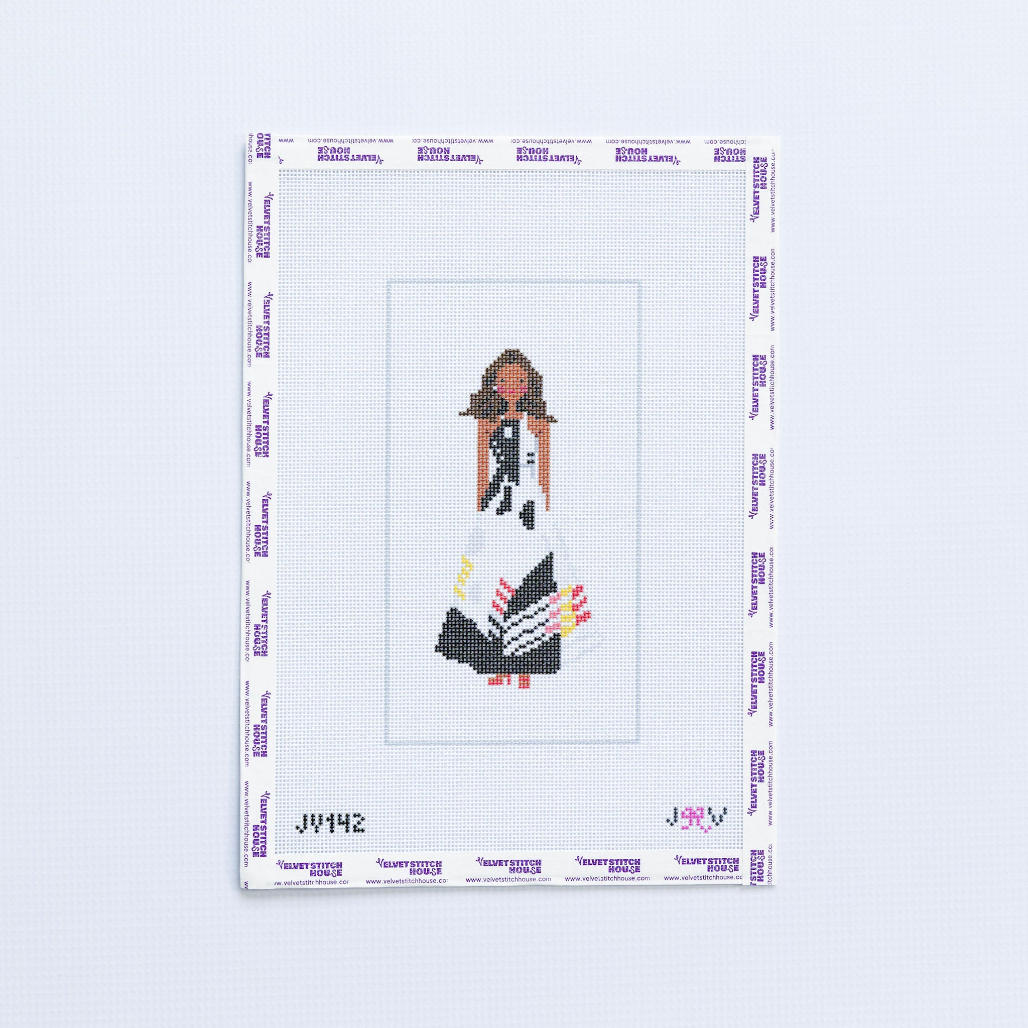 Needlepoint design of a woman Michelle Obama in a black and white dress