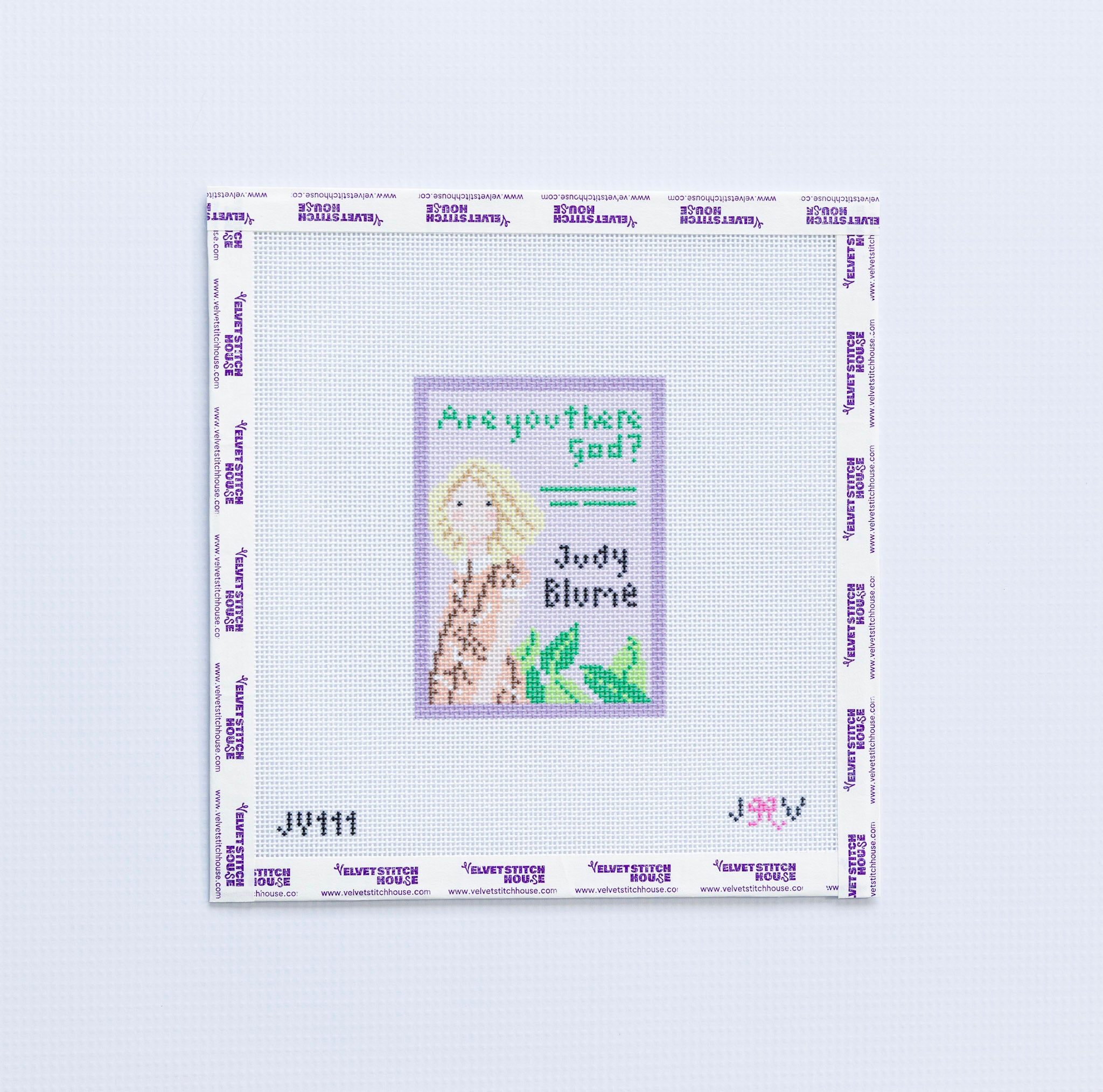 Needlepoint design with a young girl with blonde hair and text "are you there god" on a light purple background