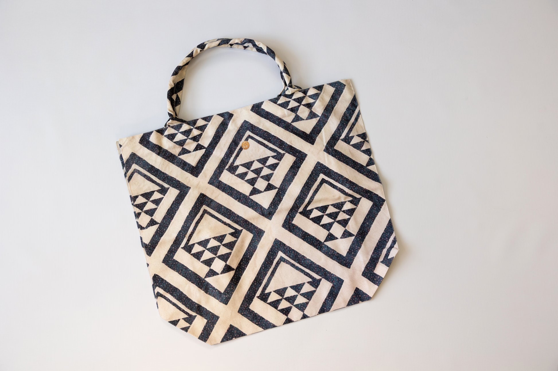 Fabric bag with geometric pattern on a white background